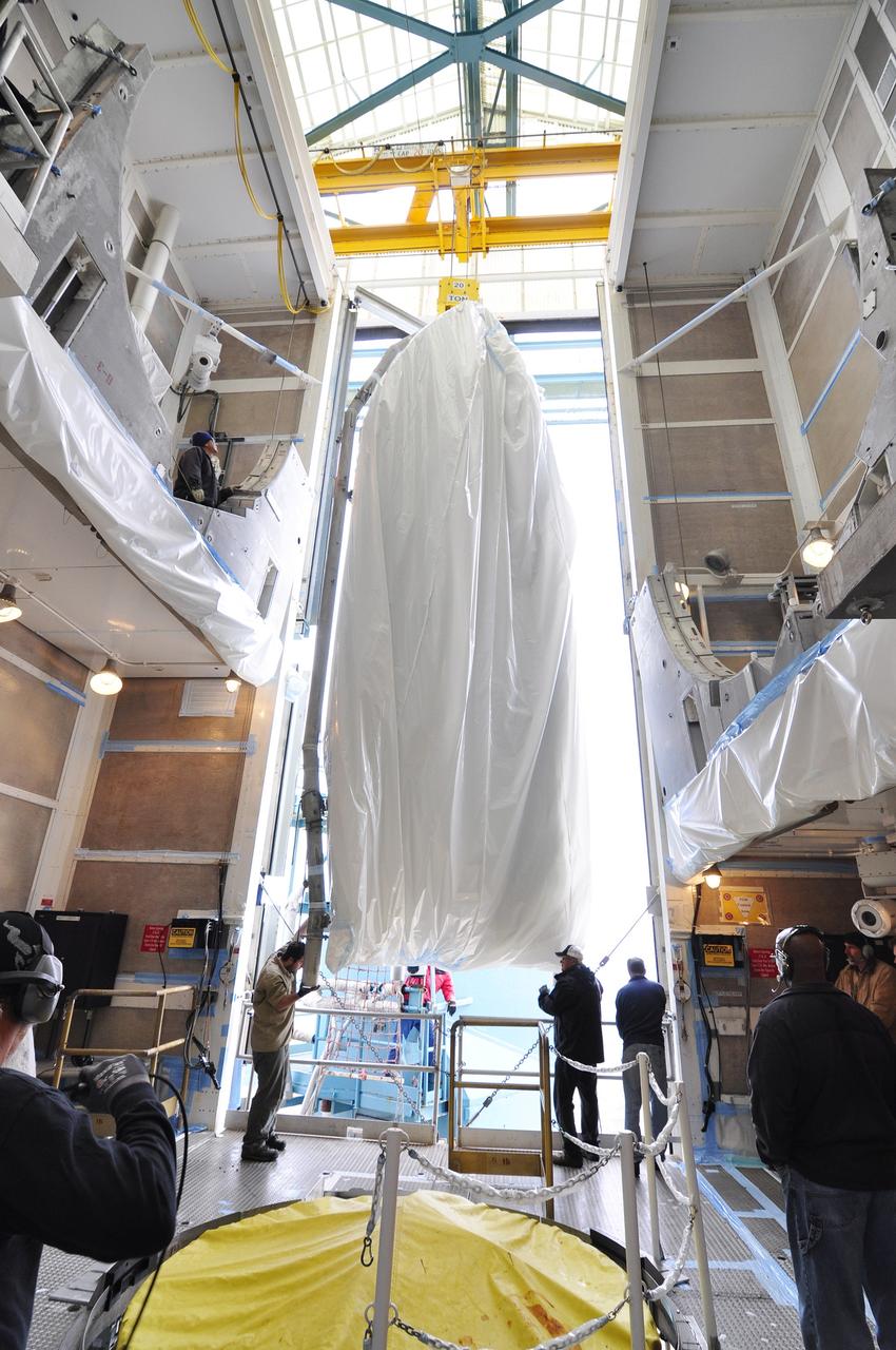 VANDENBERG AIR FORCE BASE, Calif. – A half section of the 10-foot-diameter fairing for NASA's Soil Moisture Active Passive mission, or SMAP, is transferred into the environmental enclosure at the top of the mobile service tower at Space Launch Complex 2 on Vandenberg Air Force Base in California where it will be stowed until arrival of the spacecraft.    The fairing will protect the SMAP spacecraft from the heat and aerodynamic pressure generated during its ascent to orbit aboard a United Launch Alliance Delta II rocket. SMAP will provide global measurements of soil moisture and its freeze/thaw state. These measurements will be used to enhance understanding of processes that link the water, energy and carbon cycles, and to extend the capabilities of weather and climate prediction models. SMAP data will also be used to quantify net carbon flux in boreal landscapes and to develop improved flood prediction and drought monitoring capabilities. Launch is scheduled for no earlier than November 2014. To learn more about SMAP, visit http://smap.jpl.nasa.gov.  Photo credit: NASA/Randy Beaudoin