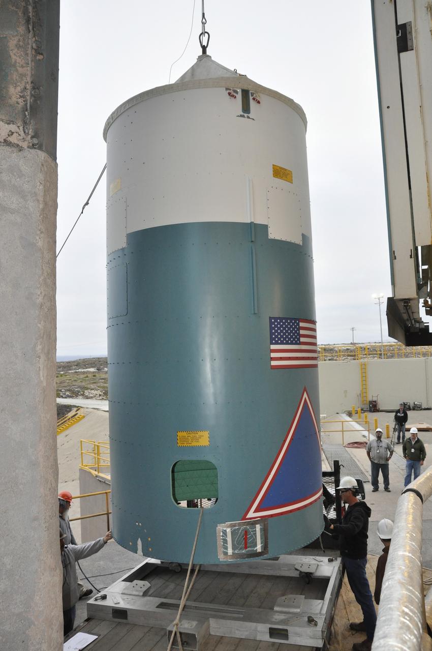 VANDENBERG AIR FORCE BASE, Calif. – The Delta II interstage adapter, or ISA, for NASA's Soil Moisture Active Passive mission, or SMAP, is lifted from the flatbed of the truck that delivered it to the mobile service tower at Space Launch Complex 2 on Vandenberg Air Force Base in California.    Processing of the United Launch Alliance Delta II rocket that will loft SMAP into orbit is underway at the pad. The ISA connects the Delta II first and second stages and encloses the second stage engine and thrust section. The spacecraft will provide global measurements of soil moisture and its freeze/thaw state. These measurements will be used to enhance understanding of processes that link the water, energy and carbon cycles, and to extend the capabilities of weather and climate prediction models. The data returned also will be used to quantify net carbon flux in boreal landscapes and to develop improved flood prediction and drought monitoring capabilities. Launch is scheduled for November 2014. To learn more about SMAP, visit http://smap.jpl.nasa.gov.  Photo credit: NASA/Randy Beaudoin