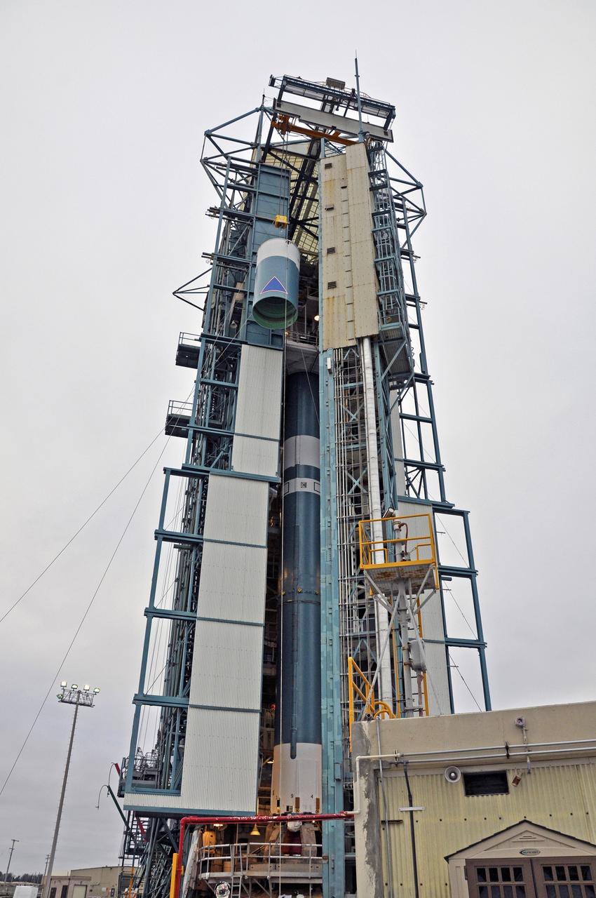 VANDENBERG AIR FORCE BASE, Calif. – The Delta II interstage adapter, or ISA, for NASA's Soil Moisture Active Passive mission, or SMAP, is lifted up the side of the mobile service tower at Space Launch Complex 2 on Vandenberg Air Force Base in California, higher than the rocket's first stage already in position in the tower.    Processing of the United Launch Alliance Delta II rocket that will loft SMAP into orbit is underway at the pad. The ISA connects the Delta II first and second stages and encloses the second stage engine and thrust section. The spacecraft will provide global measurements of soil moisture and its freeze/thaw state. These measurements will be used to enhance understanding of processes that link the water, energy and carbon cycles, and to extend the capabilities of weather and climate prediction models. The data returned also will be used to quantify net carbon flux in boreal landscapes and to develop improved flood prediction and drought monitoring capabilities. Launch is scheduled for November 2014. To learn more about SMAP, visit http://smap.jpl.nasa.gov.  Photo credit: NASA/Randy Beaudoin