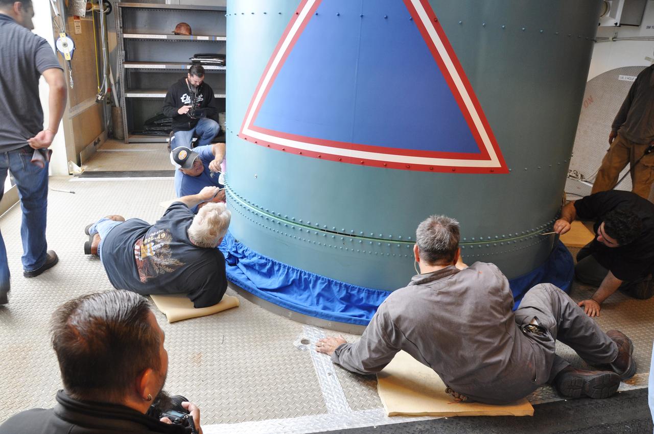VANDENBERG AIR FORCE BASE, Calif. – Workers secure the Delta II interstage adapter, or ISA, for NASA's Soil Moisture Active Passive mission, or SMAP, to the rocket's first stage in the mobile service tower at Space Launch Complex 2 on Vandenberg Air Force Base in California.      Processing of the United Launch Alliance Delta II rocket that will loft SMAP into orbit is underway at the pad. The ISA connects the Delta II first and second stages and encloses the second stage engine and thrust section. The spacecraft will provide global measurements of soil moisture and its freeze/thaw state. These measurements will be used to enhance understanding of processes that link the water, energy and carbon cycles, and to extend the capabilities of weather and climate prediction models. The data returned also will be used to quantify net carbon flux in boreal landscapes and to develop improved flood prediction and drought monitoring capabilities. Launch is scheduled for November 2014. To learn more about SMAP, visit http://smap.jpl.nasa.gov.  Photo credit: NASA/Randy Beaudoin