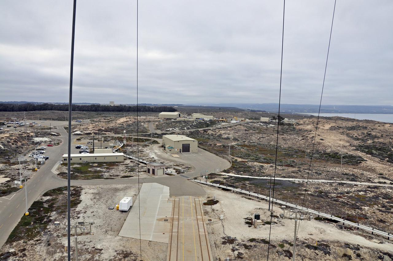 VANDENBERG AIR FORCE BASE, Calif. – This view from the mobile service tower at Space Launch Complex 2 on Vandenberg Air Force Base in California reveals the close proximity of the Horizontal Processing Facility to the pad. Processing of a United Launch Alliance Delta II rocket for NASA's Soil Moisture Active Passive mission, or SMAP, is underway at the pad. SMAP will provide global measurements of soil moisture and its freeze/thaw state. These measurements will be used to enhance understanding of processes that link the water, energy and carbon cycles, and to extend the capabilities of weather and climate prediction models. The data returned also will be used to quantify net carbon flux in boreal landscapes and to develop improved flood prediction and drought monitoring capabilities. Launch is scheduled for November 2014. To learn more about SMAP, visit http://smap.jpl.nasa.gov.  Photo credit: NASA/Randy Beaudoin