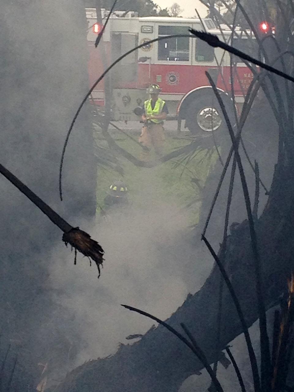 CAPE CANAVERAL, Fla. – Fire Rescue personnel douse a brush fire near Headquarters Building in the Industrial Area of NASA’s Kennedy Space Center in Florida. The fire was ignited by a lightning strike.    The space center is nestled on the Merritt Island National Wildlife Refuge, which is managed by the U.S. Fish and Wildlife Service. Chenega Security & Support Solutions is responsible for Kennedy's Fire Rescue Department. For information on the refuge, visit http://www.fws.gov/merrittisland/Index.html. For more on Kennedy Space Center, visit http://www.nasa.gov/kennedy. Photo credit: NASA/Ben Smegelsky