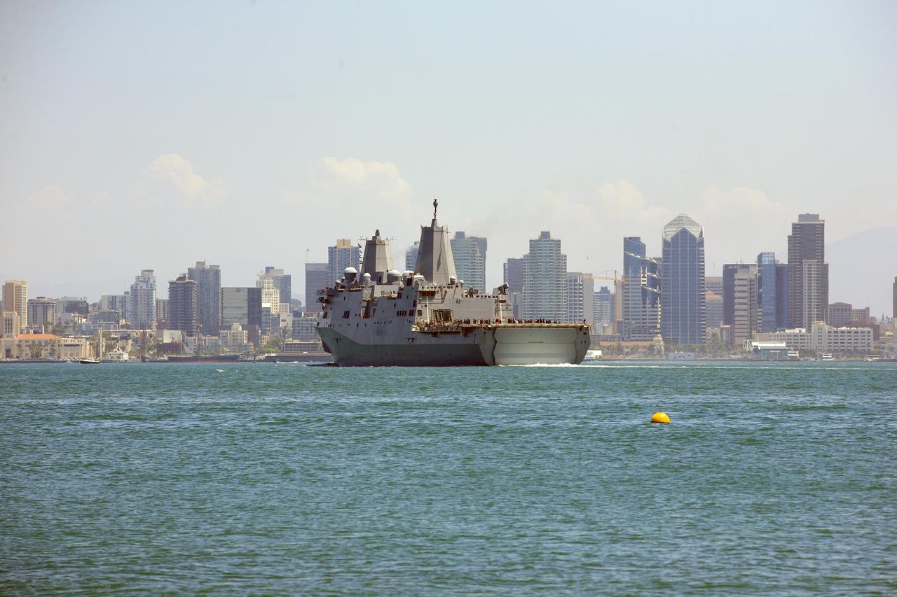 SAN DIEGO, Calif. – The USS Anchorage returns to Naval Base San Diego after completion of the Orion Underway Recovery Test 2 in the Pacific Ocean. The ship is framed by the skyline of the city of San Diego. NASA, Lockheed Martin and the U.S. Navy conducted the test on the Orion boilerplate test vehicle to prepare for recovery of the Orion crew module on its return from a deep space mission. The underway recovery test allowed the team to demonstrate and evaluate the recovery processes, procedures, new hardware and personnel in open waters.    The Ground Systems Development and Operations Program conducted the underway recovery test. Orion is the exploration spacecraft designed to carry astronauts to destinations not yet explored by humans, including an asteroid and Mars. It will have emergency abort capability, sustain the crew during space travel and provide safe re-entry from deep space return velocities. The first unpiloted test flight of the Orion is scheduled to launch in 2014 atop a Delta IV rocket and in 2017 on NASA’s Space Launch System rocket. For more information, visit http://www.nasa.gov/orion. Photo credit: NASA/Kim Shiflett