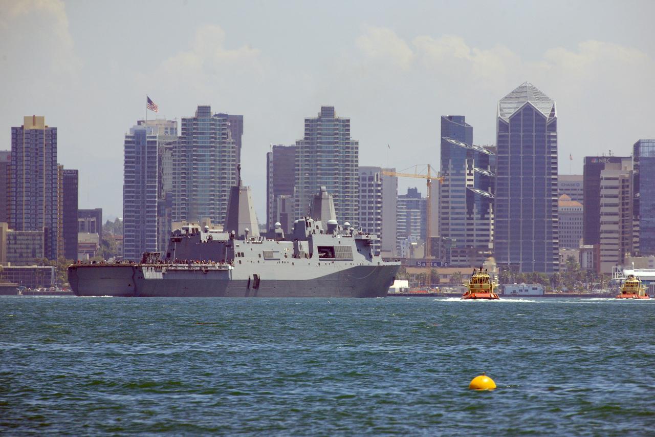 SAN DIEGO, Calif. – The USS Anchorage returns to Naval Base San Diego after completion of the Orion Underway Recovery Test 2 in the Pacific Ocean. The ship is framed by the skyline of the city of San Diego. NASA, Lockheed Martin and the U.S. Navy conducted the test on the Orion boilerplate test vehicle to prepare for recovery of the Orion crew module on its return from a deep space mission. The underway recovery test allowed the team to demonstrate and evaluate the recovery processes, procedures, new hardware and personnel in open waters.    The Ground Systems Development and Operations Program conducted the underway recovery test. Orion is the exploration spacecraft designed to carry astronauts to destinations not yet explored by humans, including an asteroid and Mars. It will have emergency abort capability, sustain the crew during space travel and provide safe re-entry from deep space return velocities. The first unpiloted test flight of the Orion is scheduled to launch in 2014 atop a Delta IV rocket and in 2017 on NASA’s Space Launch System rocket. For more information, visit http://www.nasa.gov/orion. Photo credit: NASA/Kim Shiflett