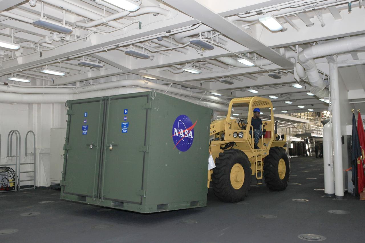 SAN DIEGO, Calif. – The USS Anchorage has returned to Naval Base San Diego after completion of the Orion Underway Recovery Test 2 in the Pacific Ocean. U.S. Navy personnel use a forklift to carry support equipment out of the ship's well deck. NASA, Lockheed Martin and the U.S. Navy conducted the test on the Orion boilerplate test vehicle to prepare for recovery of the Orion crew module on its return from a deep space mission. The underway recovery test allowed the team to demonstrate and evaluate the recovery processes, procedures, new hardware and personnel in open waters.    The Ground Systems Development and Operations Program conducted the underway recovery test. Orion is the exploration spacecraft designed to carry astronauts to destinations not yet explored by humans, including an asteroid and Mars. It will have emergency abort capability, sustain the crew during space travel and provide safe re-entry from deep space return velocities. The first unpiloted test flight of the Orion is scheduled to launch in 2014 atop a Delta IV rocket and in 2017 on NASA’s Space Launch System rocket. For more information, visit http://www.nasa.gov/orion. Photo credit: NASA/Kim Shiflett