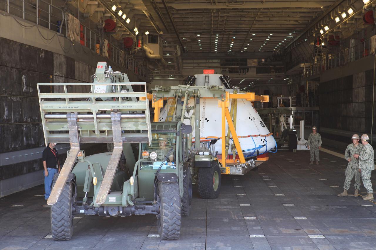 SAN DIEGO, Calif. – The USS Anchorage has docked at Naval Base San Diego after completion of the Orion Underway Recovery Test 2 in the Pacific Ocean. The Orion boilerplate test vehicle is being offloaded from the well deck of the ship. NASA, Lockheed Martin and the U.S. Navy conducted the test on the Orion boilerplate test vehicle to prepare for recovery of the Orion crew module on its return from a deep space mission. The underway recovery test allowed the team to demonstrate and evaluate the recovery processes, procedures, new hardware and personnel in open waters.    The Ground Systems Development and Operations Program conducted the underway recovery test. Orion is the exploration spacecraft designed to carry astronauts to destinations not yet explored by humans, including an asteroid and Mars. It will have emergency abort capability, sustain the crew during space travel and provide safe re-entry from deep space return velocities. The first unpiloted test flight of the Orion is scheduled to launch in 2014 atop a Delta IV rocket and in 2017 on NASA’s Space Launch System rocket. For more information, visit http://www.nasa.gov/orion. Photo credit: NASA/Kim Shiflett