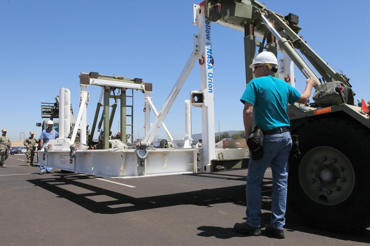 SAN DIEGO, Calif. – The Orion crew module recovery cradle has been offloaded from the well deck of the USS Anchorage at Naval Base San Diego after completion of the Orion Underway Recovery Test 2 in the Pacific Ocean. NASA, Lockheed Martin and the U.S. Navy conducted the test on the Orion boilerplate test vehicle to prepare for recovery of the Orion crew module on its return from a deep space mission. The underway recovery test allowed the team to demonstrate and evaluate the recovery processes, procedures, new hardware and personnel in open waters.    The Ground Systems Development and Operations Program conducted the underway recovery test. Orion is the exploration spacecraft designed to carry astronauts to destinations not yet explored by humans, including an asteroid and Mars. It will have emergency abort capability, sustain the crew during space travel and provide safe re-entry from deep space return velocities. The first unpiloted test flight of the Orion is scheduled to launch in 2014 atop a Delta IV rocket and in 2017 on NASA’s Space Launch System rocket. For more information, visit http://www.nasa.gov/orion. Photo credit: NASA/Kim Shiflett