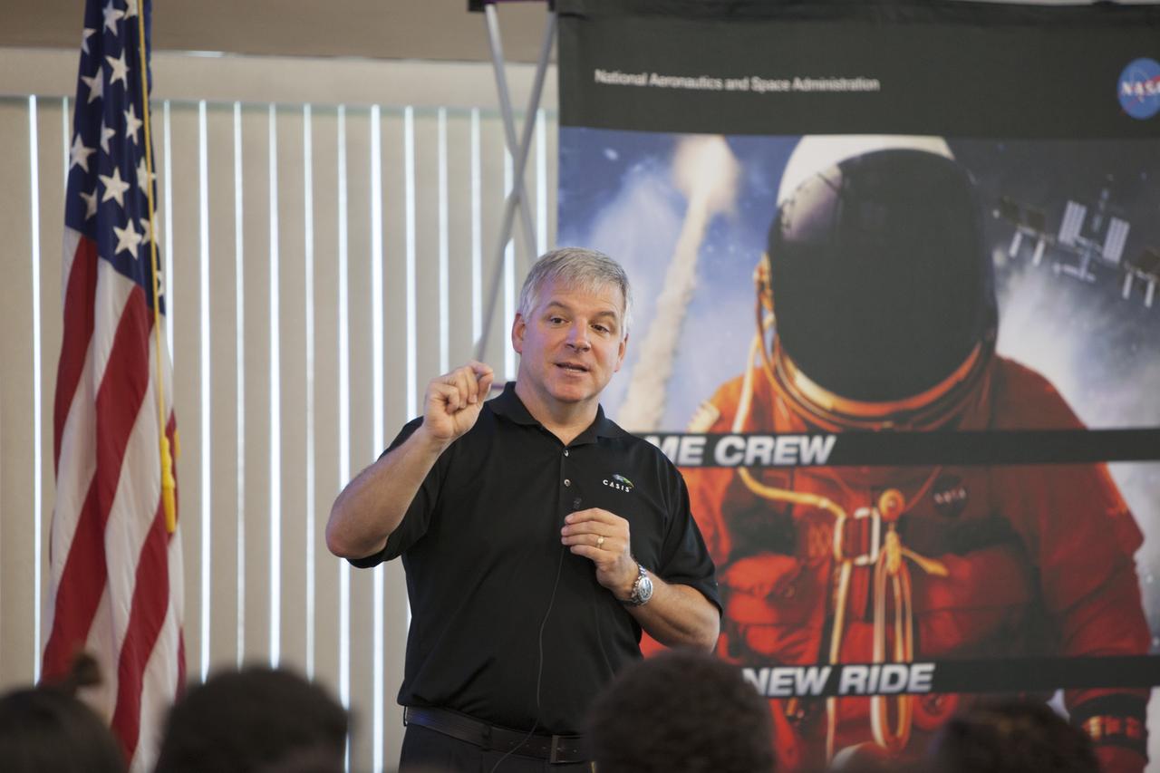 CAPE CANAVERAL, Fla. – Former astronaut Greg Johnson, executive director of the Center for the Advancement of Science in Space, talks to Florida middle school students and their teachers before the start of the Zero Robotics finals competition at NASA Kennedy Space Center's Space Station Processing Facility in Florida. Students designed software to control Synchronized Position Hold Engage and Reorient Experimental Satellites, or SPHERES, and competed with other teams locally. The Zero Robotics is a robotics programming competition where the robots are SPHERES. The competition starts online, where teams program the SPHERES to solve an annual challenge. After several phases of virtual competition in a simulation environment that mimics the real SPHERES, finalists are selected to compete in a live championship aboard the space station. Students compete to win a technically challenging game by programming their strategies into the SPHERES satellites. The programs are autonomous and the students cannot control the satellites during the test. Photo credit: NASA/Daniel Casper