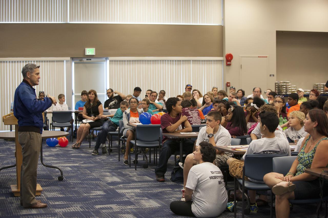 CAPE CANAVERAL, Fla. – Kennedy Space Center Director and former astronaut Bob Cabana, talks to Florida middle school students and their teachers during the Zero Robotics finals competition at the center's Space Station Processing Facility in Florida. Students designed software to control Synchronized Position Hold Engage and Reorient Experimental Satellites, or SPHERES, and competed with other teams locally. The Zero Robotics is a robotics programming competition where the robots are SPHERES. The competition starts online, where teams program the SPHERES to solve an annual challenge. After several phases of virtual competition in a simulation environment that mimics the real SPHERES, finalists are selected to compete in a live championship aboard the space station. Students compete to win a technically challenging game by programming their strategies into the SPHERES satellites. The programs are autonomous and the students cannot control the satellites during the test. Photo credit: NASA/Daniel Casper