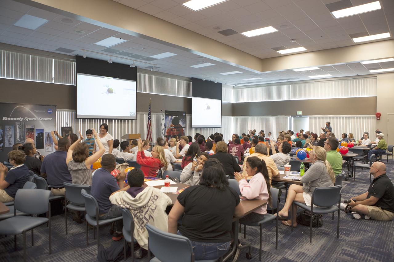 CAPE CANAVERAL, Fla. – Florida middle school students and their teachers watch the Zero Robotics finals competition broadcast live via webex from the International Space Station. The Florida teams are at the Space Station Processing Facility at NASA's Kennedy Space Center in Florida. Students designed software to control Synchronized Position Hold Engage and Reorient Experimental Satellites, or SPHERES, and competed with other teams locally. The Zero Robotics is a robotics programming competition where the robots are SPHERES. The competition starts online, where teams program the SPHERES to solve an annual challenge. After several phases of virtual competition in a simulation environment that mimics the real SPHERES, finalists are selected to compete in a live championship aboard the space station. Students compete to win a technically challenging game by programming their strategies into the SPHERES satellites. The programs are autonomous and the students cannot control the satellites during the test. Photo credit: NASA/Daniel Casper