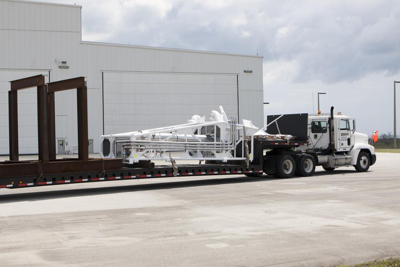 CAPE CANAVERAL, Fla. – Part of the umbilical swing arm for Exploration Flight Test 1, or EFT-1, arrives at the Horizontal Integration Facility near Space Launch Complex 37 at Cape Canaveral Air Force Station in Florida. The swing arm is the uppermost of three swing arms that will be attached to the fixed umbilical tower on the launch pad.    The swing arm will carry umbilicals that will be mated to Orion's launch abort system and environmental control system. During launch, the umbilicals will pull away from Orion and the United Launch Alliance Delta IV Heavy rocket at T-0. During the EFT-1 mission, Orion will travel farther into space than any human spacecraft has gone in more than 40 years.  The data gathered during the flight will influence design decisions, validate existing computer models and innovative new approaches to space systems development, as well as reduce overall mission risks and costs for later Orion flights. Liftoff of Orion on its first flight test is planned for fall 2014. Photo credit: NASA/Kim Shiflett