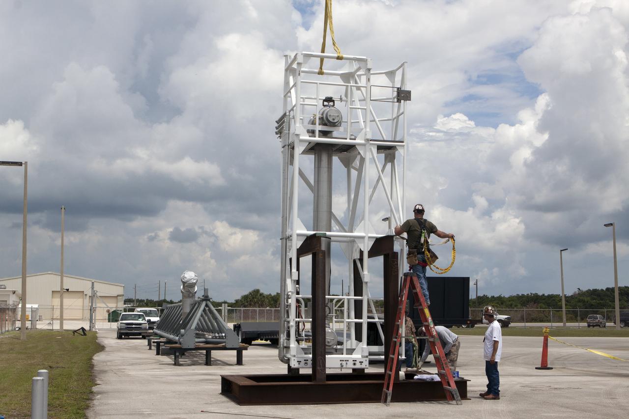 CAPE CANAVERAL, Fla. – Both parts of the umbilical swing arm for Exploration Flight Test 1, or EFT-1, have arrived at the Horizontal Integration Facility near Space Launch Complex 37 at Cape Canaveral Air Force Station in Florida. They have been removed from the transporter and placed on stands. The swing arm is the uppermost of three swing arms that will be attached to the fixed umbilical tower on the launch pad.    The swing arm will carry umbilicals that will be mated to Orion's launch abort system and environmental control system. During launch, the umbilicals will pull away from Orion and the United Launch Alliance Delta IV Heavy rocket at T-0. During the EFT-1 mission, Orion will travel farther into space than any human spacecraft has gone in more than 40 years.  The data gathered during the flight will influence design decisions, validate existing computer models and innovative new approaches to space systems development, as well as reduce overall mission risks and costs for later Orion flights. Liftoff of Orion on its first flight test is planned for fall 2014. Photo credit: NASA/Kim Shiflett