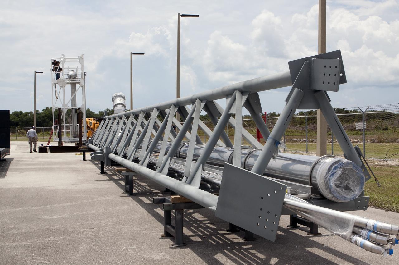 CAPE CANAVERAL, Fla. – Both parts of the umbilical swing arm for Exploration Flight Test 1, or EFT-1, have arrived at the Horizontal Integration Facility near Space Launch Complex 37 at Cape Canaveral Air Force Station in Florida. They have been removed from the transporter and placed on stands. The swing arm is the uppermost of three swing arms that will be attached to the fixed umbilical tower on the launch pad.    The swing arm will carry umbilicals that will be mated to Orion's launch abort system and environmental control system. During launch, the umbilicals will pull away from Orion and the United Launch Alliance Delta IV Heavy rocket at T-0. During the EFT-1 mission, Orion will travel farther into space than any human spacecraft has gone in more than 40 years.  The data gathered during the flight will influence design decisions, validate existing computer models and innovative new approaches to space systems development, as well as reduce overall mission risks and costs for later Orion flights. Liftoff of Orion on its first flight test is planned for fall 2014. Photo credit: NASA/Kim Shiflett