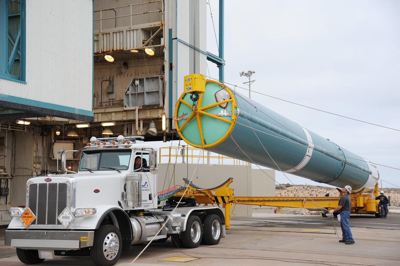 VANDENBERG AIR FORCE BASE, Calif. – The first stage of the United Launch Alliance Delta II rocket for NASA's Soil Moisture Active Passive mission, or SMAP, is raised off its transporter into a vertical position for its transfer into the mobile service tower at Space Launch Complex 2 on Vandenberg Air Force Base in California. SMAP will provide global measurements of soil moisture and its freeze/thaw state. These measurements will be used to enhance understanding of processes that link the water, energy and carbon cycles, and to extend the capabilities of weather and climate prediction models. SMAP data also will be used to quantify net carbon flux in boreal landscapes and to develop improved flood prediction and drought monitoring capabilities. Launch is scheduled for November 2014. To learn more about SMAP, visit http://smap.jpl.nasa.gov. Photo credit: NASA/Tony Vauccin, USAF