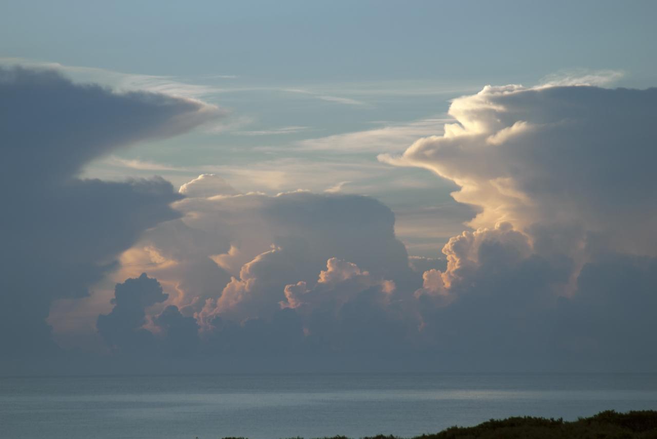 CAPE CANAVERAL, Fla. – Towering cumulonimbus clouds cast shadows on the water during the early morning in this view looking east toward the Atlantic Ocean from the Space Launch Complex 37 area at Cape Canaveral Air Force Station in Florida. Photo credit: NASA/Jim Grossmann