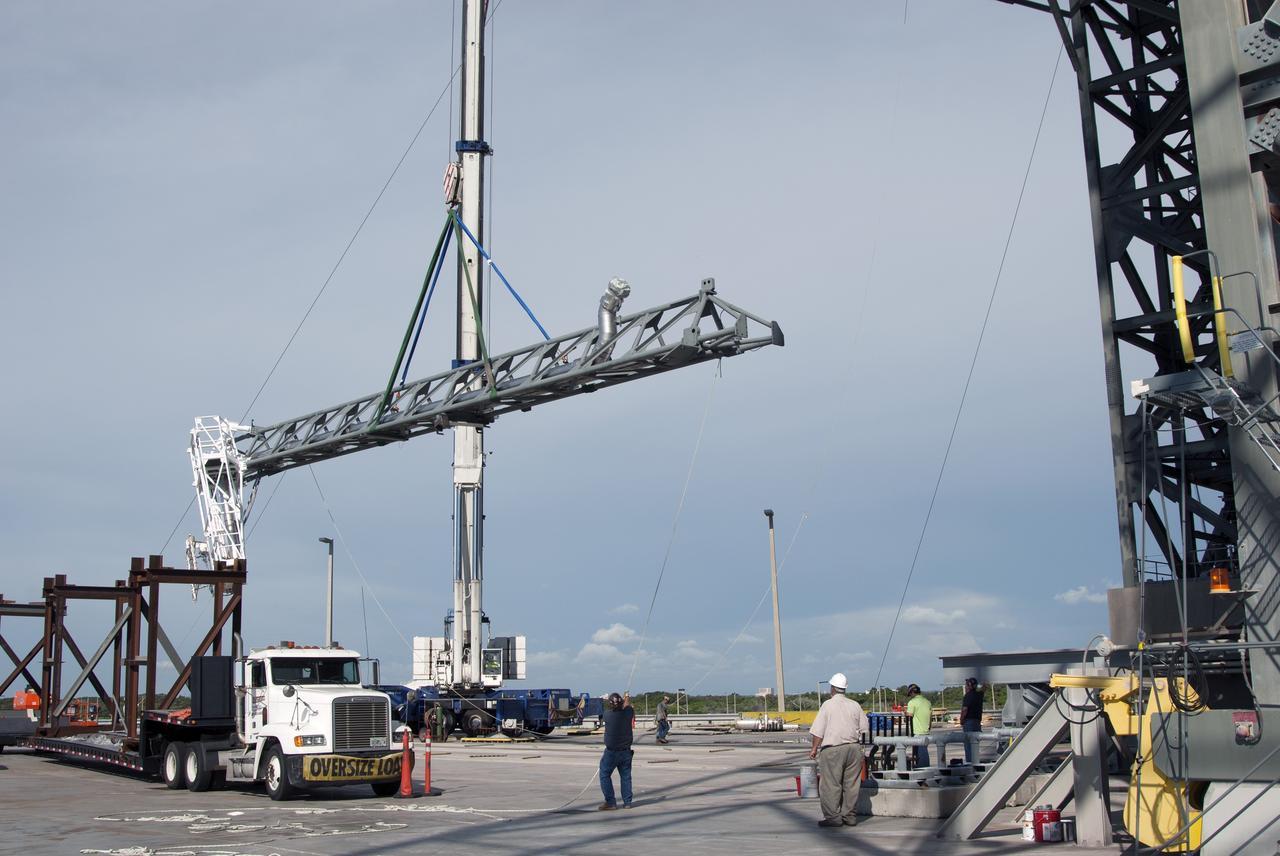 CAPE CANAVERAL, Fla. – The umbilical swing arm for Exploration Flight Test 1, or EFT-1, is lifted by crane for installation on the fixed umbilical tower at Space Launch Complex 37 at Cape Canaveral Air Force Station in Florida. The swing arm is the uppermost of three swing arms that will be attached to the fixed umbilical tower.    The swing arm will carry umbilicals that will be mated to Orion's launch abort system and environmental control system. During launch, the umbilicals will pull away from Orion and the United Launch Alliance Delta IV Heavy rocket at T-0. During the EFT-1 mission, Orion will travel farther into space than any human spacecraft has gone in more than 40 years.  The data gathered during the flight will influence design decisions, validate existing computer models and innovative new approaches to space systems development, as well as reduce overall mission risks and costs for later Orion flights. Liftoff of Orion on its first flight test is planned for fall 2014. Photo credit: NASA/Jim Grossmann