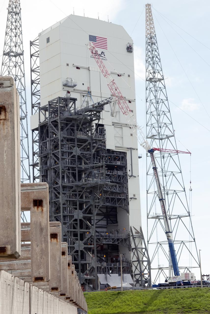 CAPE CANAVERAL, Fla. – A crane brings the umbilical swing arm for Exploration Flight Test 1, or EFT-1, closer for installation on the fixed umbilical tower at Space Launch Complex 37 at Cape Canaveral Air Force Station in Florida. The swing arm is the uppermost of three swing arms that will be attached to the fixed umbilical tower.    The swing arm will carry umbilicals that will be mated to Orion's launch abort system and environmental control system. During launch, the umbilicals will pull away from Orion and the United Launch Alliance Delta IV Heavy rocket at T-0. During the EFT-1 mission, Orion will travel farther into space than any human spacecraft has gone in more than 40 years.  The data gathered during the flight will influence design decisions, validate existing computer models and innovative new approaches to space systems development, as well as reduce overall mission risks and costs for later Orion flights. Liftoff of Orion on its first flight test is planned for fall 2014. Photo credit: NASA/Jim Grossmann
