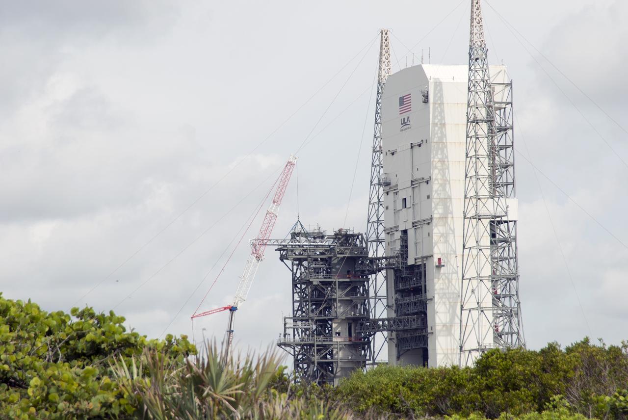 CAPE CANAVERAL, Fla. – A crane brings the umbilical swing arm for Exploration Flight Test 1, or EFT-1, closer for installation on the fixed umbilical tower at Space Launch Complex 37 at Cape Canaveral Air Force Station in Florida. The swing arm is the uppermost of three swing arms that will be attached to the fixed umbilical tower.    The swing arm will carry umbilicals that will be mated to Orion's launch abort system and environmental control system. During launch, the umbilicals will pull away from Orion and the United Launch Alliance Delta IV Heavy rocket at T-0. During the EFT-1 mission, Orion will travel farther into space than any human spacecraft has gone in more than 40 years.  The data gathered during the flight will influence design decisions, validate existing computer models and innovative new approaches to space systems development, as well as reduce overall mission risks and costs for later Orion flights. Liftoff of Orion on its first flight test is planned for fall 2014. Photo credit: NASA/Jim Grossmann