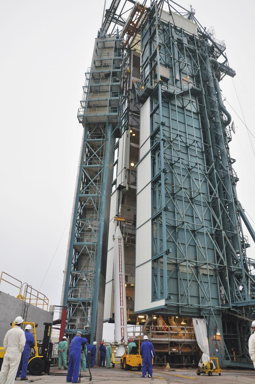 VANDENBERG AIR FORCE BASE, Calif. – A solid rocket motor for the Delta II rocket for NASA's Soil Moisture Active Passive mission, or SMAP, is lifted alongside the mobile service tower at Space Launch Complex 2 on Vandenberg Air Force Base in California.    SMAP will be launched on a Delta II 7320 configuration vehicle featuring a United Launch Alliance first stage booster powered by an Aerojet Rocketdyne RS-27A main engine and three Alliant Techsystems, or ATK, strap-on solid rocket motors. Once on station in Earth orbit, SMAP will provide global measurements of soil moisture and its freeze/thaw state. These measurements will be used to enhance understanding of processes that link the water, energy and carbon cycles, and to extend the capabilities of weather and climate prediction models. SMAP data also will be used to quantify net carbon flux in boreal landscapes and to develop improved flood prediction and drought monitoring capabilities. Launch is scheduled for no earlier than November 2014. To learn more about SMAP, visit http://smap.jpl.nasa.gov.  Photo credit: NASA/Randy Beaudoin