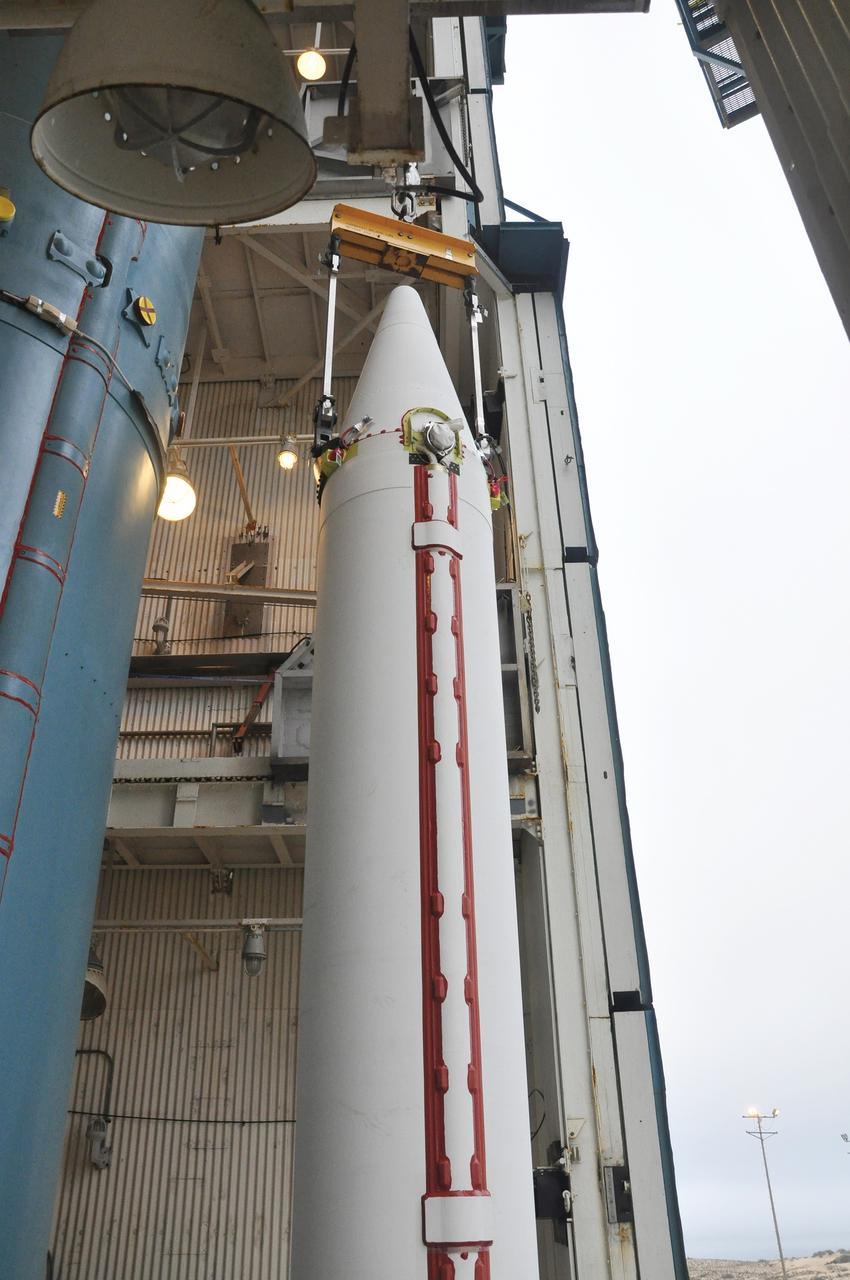 VANDENBERG AIR FORCE BASE, Calif. – A crane is enlisted to position a solid rocket motor for the Delta II rocket for NASA's Soil Moisture Active Passive mission, or SMAP, beside the rocket's first stage in the mobile service tower at Space Launch Complex 2 on Vandenberg Air Force Base in California.    SMAP will be launched on a Delta II 7320 configuration vehicle featuring a United Launch Alliance first stage booster powered by an Aerojet Rocketdyne RS-27A main engine and three Alliant Techsystems, or ATK, strap-on solid rocket motors. Once on station in Earth orbit, SMAP will provide global measurements of soil moisture and its freeze/thaw state. These measurements will be used to enhance understanding of processes that link the water, energy and carbon cycles, and to extend the capabilities of weather and climate prediction models. SMAP data also will be used to quantify net carbon flux in boreal landscapes and to develop improved flood prediction and drought monitoring capabilities. Launch is scheduled for no earlier than November 2014. To learn more about SMAP, visit http://smap.jpl.nasa.gov.  Photo credit: NASA/Randy Beaudoin