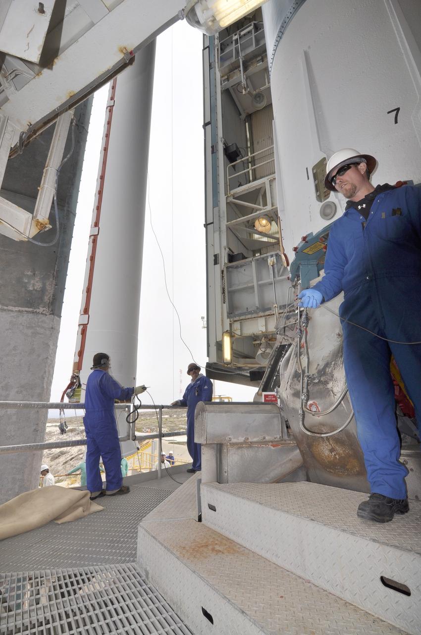 VANDENBERG AIR FORCE BASE, Calif. – Workers monitor a second solid rocket motor for the Delta II rocket for NASA's Soil Moisture Active Passive mission, or SMAP, as it is lifted into the mobile service tower at Space Launch Complex 2 on Vandenberg Air Force Base in California beside the rocket's first stage.    SMAP will be launched on a Delta II 7320 configuration vehicle featuring a United Launch Alliance first stage booster powered by an Aerojet Rocketdyne RS-27A main engine and three Alliant Techsystems, or ATK, strap-on solid rocket motors. Once on station in Earth orbit, SMAP will provide global measurements of soil moisture and its freeze/thaw state. These measurements will be used to enhance understanding of processes that link the water, energy and carbon cycles, and to extend the capabilities of weather and climate prediction models. SMAP data also will be used to quantify net carbon flux in boreal landscapes and to develop improved flood prediction and drought monitoring capabilities. Launch is scheduled for no earlier than November 2014. To learn more about SMAP, visit http://smap.jpl.nasa.gov.  Photo credit: NASA/Randy Beaudoin