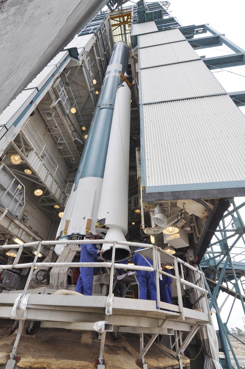 VANDENBERG AIR FORCE BASE, Calif. – Solid rocket motor installation progresses on the Delta II rocket for NASA's Soil Moisture Active Passive mission, or SMAP, with the attachment of the second motor to the rocket's first stage in the mobile service tower at Space Launch Complex 2 on Vandenberg Air Force Base in California.    SMAP will be launched on a Delta II 7320 configuration vehicle featuring a United Launch Alliance first stage booster powered by an Aerojet Rocketdyne RS-27A main engine and three Alliant Techsystems, or ATK, strap-on solid rocket motors. Once on station in Earth orbit, SMAP will provide global measurements of soil moisture and its freeze/thaw state. These measurements will be used to enhance understanding of processes that link the water, energy and carbon cycles, and to extend the capabilities of weather and climate prediction models. SMAP data also will be used to quantify net carbon flux in boreal landscapes and to develop improved flood prediction and drought monitoring capabilities. Launch is scheduled for no earlier than November 2014. To learn more about SMAP, visit http://smap.jpl.nasa.gov.  Photo credit: NASA/Randy Beaudoin