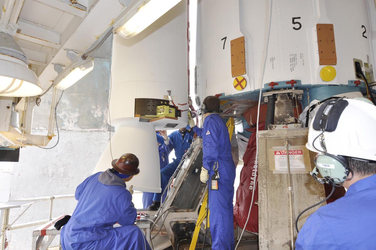 VANDENBERG AIR FORCE BASE, Calif. – Workers inside the mobile service tower use headsets to ensure communication with each other and their fellow workers outside the tower during operations to install the solid rocket motors on the first stage of the Delta II rocket for NASA's Soil Moisture Active Passive mission, or SMAP, at Space Launch Complex 2 on Vandenberg Air Force Base in California.    SMAP will be launched on a Delta II 7320 configuration vehicle featuring a United Launch Alliance first stage booster powered by an Aerojet Rocketdyne RS-27A main engine and three Alliant Techsystems, or ATK, strap-on solid rocket motors. Once on station in Earth orbit, SMAP will provide global measurements of soil moisture and its freeze/thaw state. These measurements will be used to enhance understanding of processes that link the water, energy and carbon cycles, and to extend the capabilities of weather and climate prediction models. SMAP data also will be used to quantify net carbon flux in boreal landscapes and to develop improved flood prediction and drought monitoring capabilities. Launch is scheduled for no earlier than November 2014. To learn more about SMAP, visit http://smap.jpl.nasa.gov.  Photo credit: NASA/Randy Beaudoin