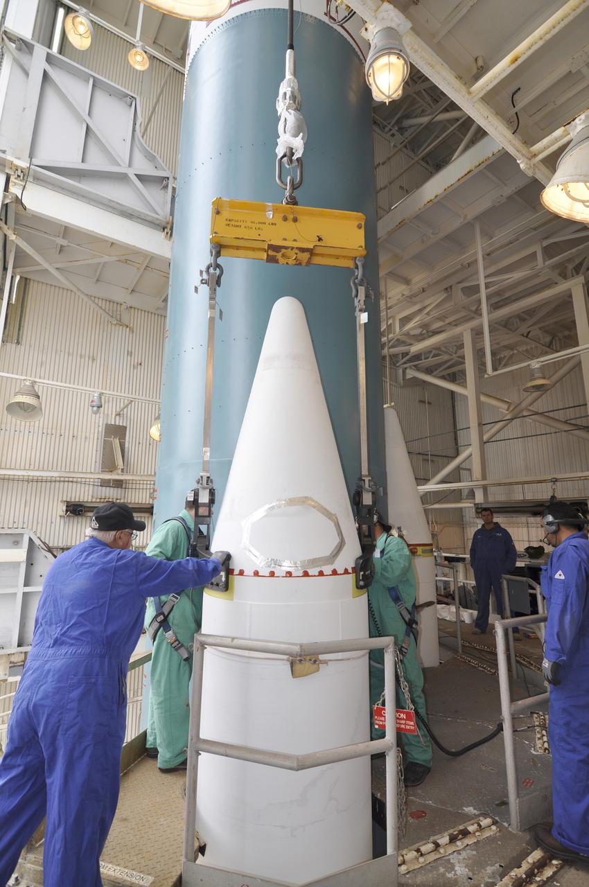 VANDENBERG AIR FORCE BASE, Calif. – Workers secure the second solid rocket motor for the Delta II rocket for NASA's Soil Moisture Active Passive mission, or SMAP, onto the rocket's first stage in the mobile service tower at Space Launch Complex 2 on Vandenberg Air Force Base in California.     SMAP will be launched on a Delta II 7320 configuration vehicle featuring a United Launch Alliance first stage booster powered by an Aerojet Rocketdyne RS-27A main engine and three Alliant Techsystems, or ATK, strap-on solid rocket motors. Once on station in Earth orbit, SMAP will provide global measurements of soil moisture and its freeze/thaw state. These measurements will be used to enhance understanding of processes that link the water, energy and carbon cycles, and to extend the capabilities of weather and climate prediction models. SMAP data also will be used to quantify net carbon flux in boreal landscapes and to develop improved flood prediction and drought monitoring capabilities. Launch is scheduled for no earlier than November 2014. To learn more about SMAP, visit http://smap.jpl.nasa.gov.  Photo credit: NASA/Randy Beaudoin