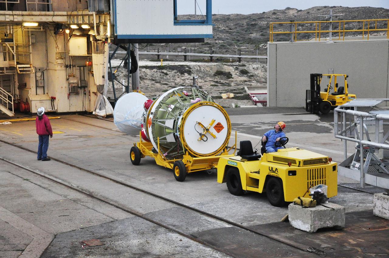 VANDENBERG AIR FORCE BASE, Calif. – The second stage of the Delta II rocket for NASA's Soil Moisture Active Passive mission, or SMAP, is delivered to the mobile service tower at Space Launch Complex 2 on Vandenberg Air Force Base in California.     Operations are underway to install the second stage atop the rocket's first stage. SMAP will launch on a Delta II 7320 configuration vehicle featuring a United Launch Alliance first stage booster powered by an Aerojet Rocketdyne RS-27A main engine and three Alliant Techsystems, or ATK, strap-on solid rocket motors. Once on station in Earth orbit, SMAP will provide global measurements of soil moisture and its freeze/thaw state. These measurements will be used to enhance understanding of processes that link the water, energy and carbon cycles, and to extend the capabilities of weather and climate prediction models. SMAP data also will be used to quantify net carbon flux in boreal landscapes and to develop improved flood prediction and drought monitoring capabilities. Launch is scheduled for no earlier than November 2014. To learn more about SMAP, visit http://smap.jpl.nasa.gov.  Photo credit: NASA/Randy Beaudoin