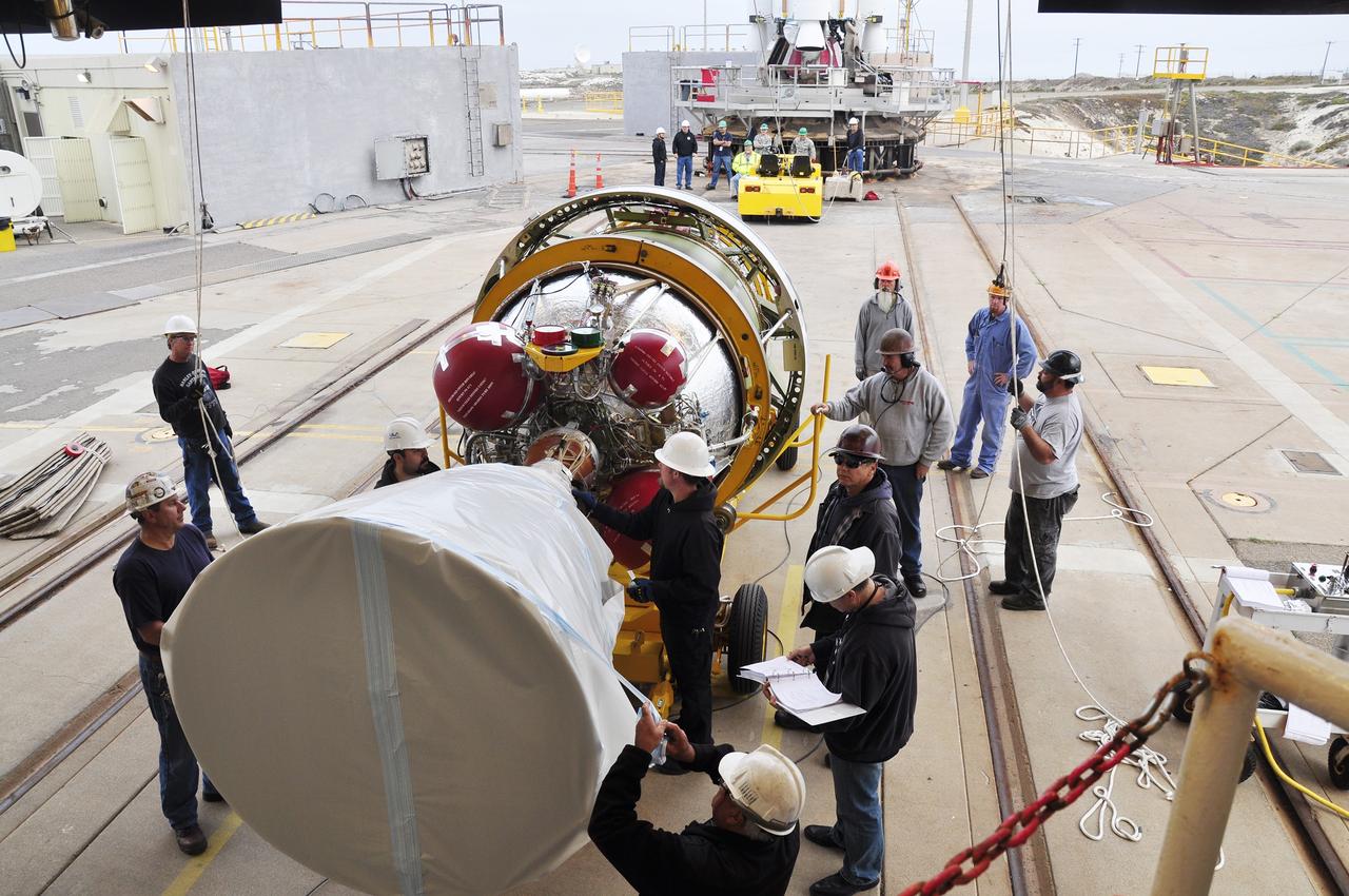 VANDENBERG AIR FORCE BASE, Calif. – Workers prepare the second stage of the Delta II rocket for NASA's Soil Moisture Active Passive mission, or SMAP, for its lift into the mobile service tower at Space Launch Complex 2 on Vandenberg Air Force Base in California. Operations are underway to install the second stage atop the rocket's first stage. SMAP will launch on a Delta II 7320 configuration vehicle featuring a United Launch Alliance first stage booster powered by an Aerojet Rocketdyne RS-27A main engine and three Alliant Techsystems, or ATK, strap-on solid rocket motors. Once on station in Earth orbit, SMAP will provide global measurements of soil moisture and its freeze/thaw state. These measurements will be used to enhance understanding of processes that link the water, energy and carbon cycles, and to extend the capabilities of weather and climate prediction models. SMAP data also will be used to quantify net carbon flux in boreal landscapes and to develop improved flood prediction and drought monitoring capabilities. Launch is scheduled for no earlier than November 2014. To learn more about SMAP, visit http://smap.jpl.nasa.gov. Photo credit: NASA/Randy Beaudoin