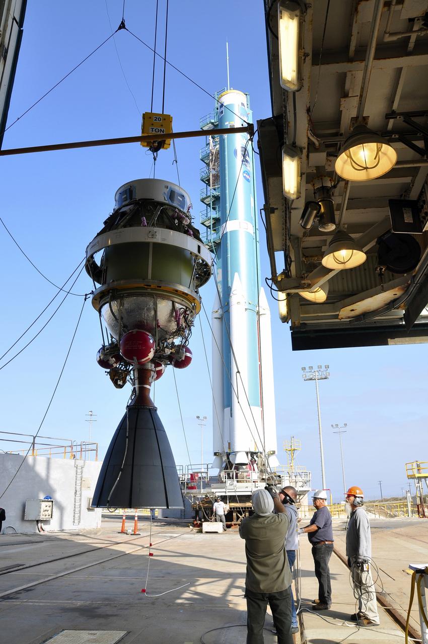 VANDENBERG AIR FORCE BASE, Calif. – The second stage of the Delta II rocket for NASA's Soil Moisture Active Passive mission, or SMAP, is attached to a crane for its lift into the mobile service tower at Space Launch Complex 2 on Vandenberg Air Force Base in California.    Operations are underway to install the second stage atop the rocket's first stage. SMAP will launch on a Delta II 7320 configuration vehicle featuring a United Launch Alliance first stage booster powered by an Aerojet Rocketdyne RS-27A main engine and three Alliant Techsystems, or ATK, strap-on solid rocket motors. Once on station in Earth orbit, SMAP will provide global measurements of soil moisture and its freeze/thaw state. These measurements will be used to enhance understanding of processes that link the water, energy and carbon cycles, and to extend the capabilities of weather and climate prediction models. SMAP data also will be used to quantify net carbon flux in boreal landscapes and to develop improved flood prediction and drought monitoring capabilities. Launch is scheduled for no earlier than November 2014. To learn more about SMAP, visit http://smap.jpl.nasa.gov.  Photo credit: NASA/Randy Beaudoin