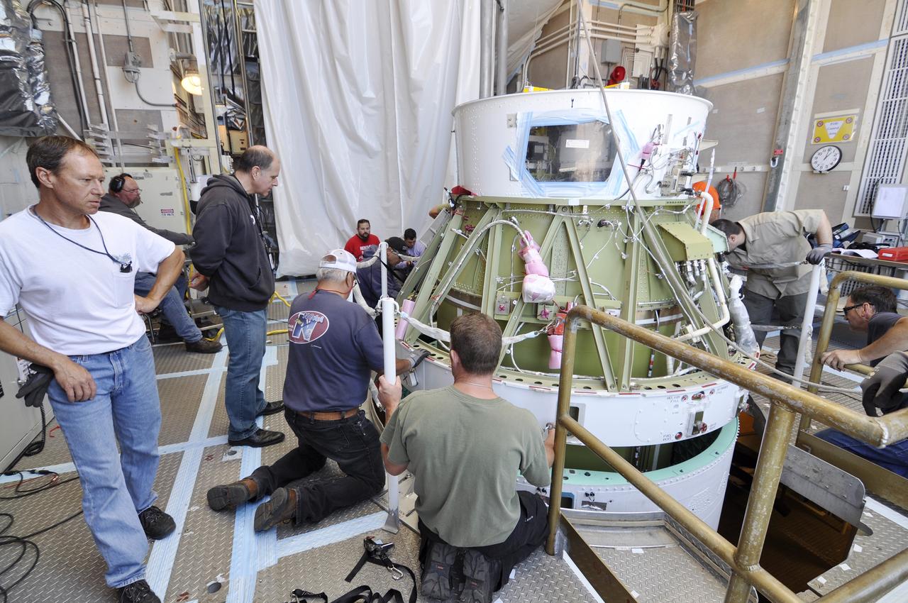 VANDENBERG AIR FORCE BASE, Calif. – Workers align the second stage of the Delta II rocket for NASA's Soil Moisture Active Passive mission, or SMAP, on the rocket's first stage in the mobile service tower at Space Launch Complex 2 on Vandenberg Air Force Base in California.    Operations are underway to install the second stage atop the rocket's first stage. SMAP will launch on a Delta II 7320 configuration vehicle featuring a United Launch Alliance first stage booster powered by an Aerojet Rocketdyne RS-27A main engine and three Alliant Techsystems, or ATK, strap-on solid rocket motors. Once on station in Earth orbit, SMAP will provide global measurements of soil moisture and its freeze/thaw state. These measurements will be used to enhance understanding of processes that link the water, energy and carbon cycles, and to extend the capabilities of weather and climate prediction models. SMAP data also will be used to quantify net carbon flux in boreal landscapes and to develop improved flood prediction and drought monitoring capabilities. Launch is scheduled for no earlier than November 2014. To learn more about SMAP, visit http://smap.jpl.nasa.gov.  Photo credit: NASA/Randy Beaudoin
