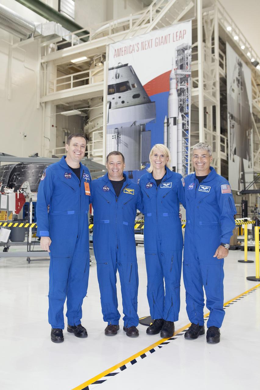 CAPE CANAVERAL, Fla. – NASA astronauts tour the Neil Armstrong Operations and Checkout Building high bay at NASA's Kennedy Space Center in Florida, and view the Orion forward bay cover for Exploration Flight Test-1. From left, are Jack Fischer, Scott Tingle, Katie Rubins and Mark Vande Hei. Orion is the exploration spacecraft designed to carry astronauts to destinations not yet explored by humans, including an asteroid and Mars. It will have emergency abort capability, sustain the crew during space travel and provide safe re-entry from deep space return velocities. The first unpiloted test flight of Orion is scheduled to launch in 2014 atop a United Launch Alliance Delta IV rocket and in 2018 on NASA’s Space Launch System rocket. For more information, visit www.nasa.gov/orion. Photo credit: Dimitri Gerondidakis