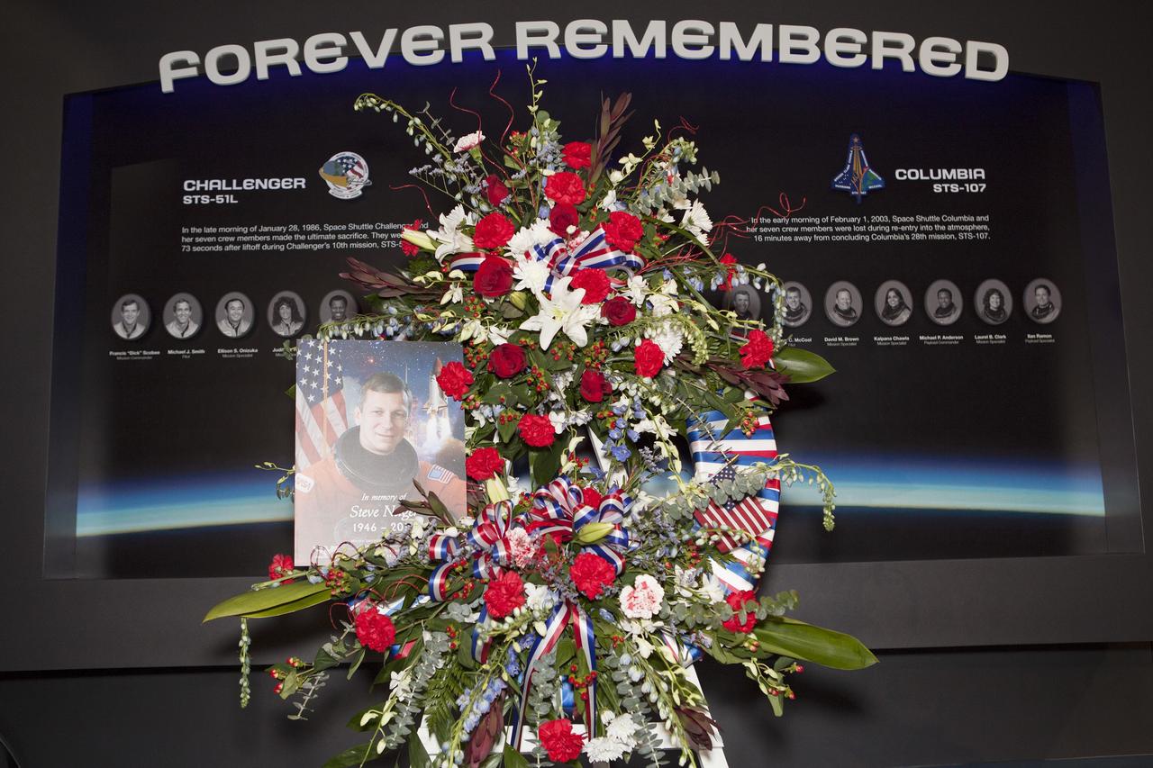 CAPE CANAVERAL, Fla. -- A wreath honoring former NASA astronaut Steven R. Nagel is displayed beside his photo at the Space Shuttle Atlantis exhibit at the Kennedy Space Center Visitor Complex in Florida. Nagel died Aug. 21 after a long illness. He was 67 years old. Nagel served as a mission specialist on his first space shuttle flight, STS-51G, in 1985. He was pilot on his second shuttle flight, STS-61A, also in 1985. He commanded his final two flights, STS-37 and STS-55, in 1991 and 1993, respectively. He logged a total of 723 hours in space. To learn more about Nagel's career, visit http://www.nasa.gov/press/2014/august/former-nasa-astronaut-steven-nagel-veteran-of-four-shuttle-flights-dies-at-67/. Photo credit: NASA/Dimitri Gerondidakis