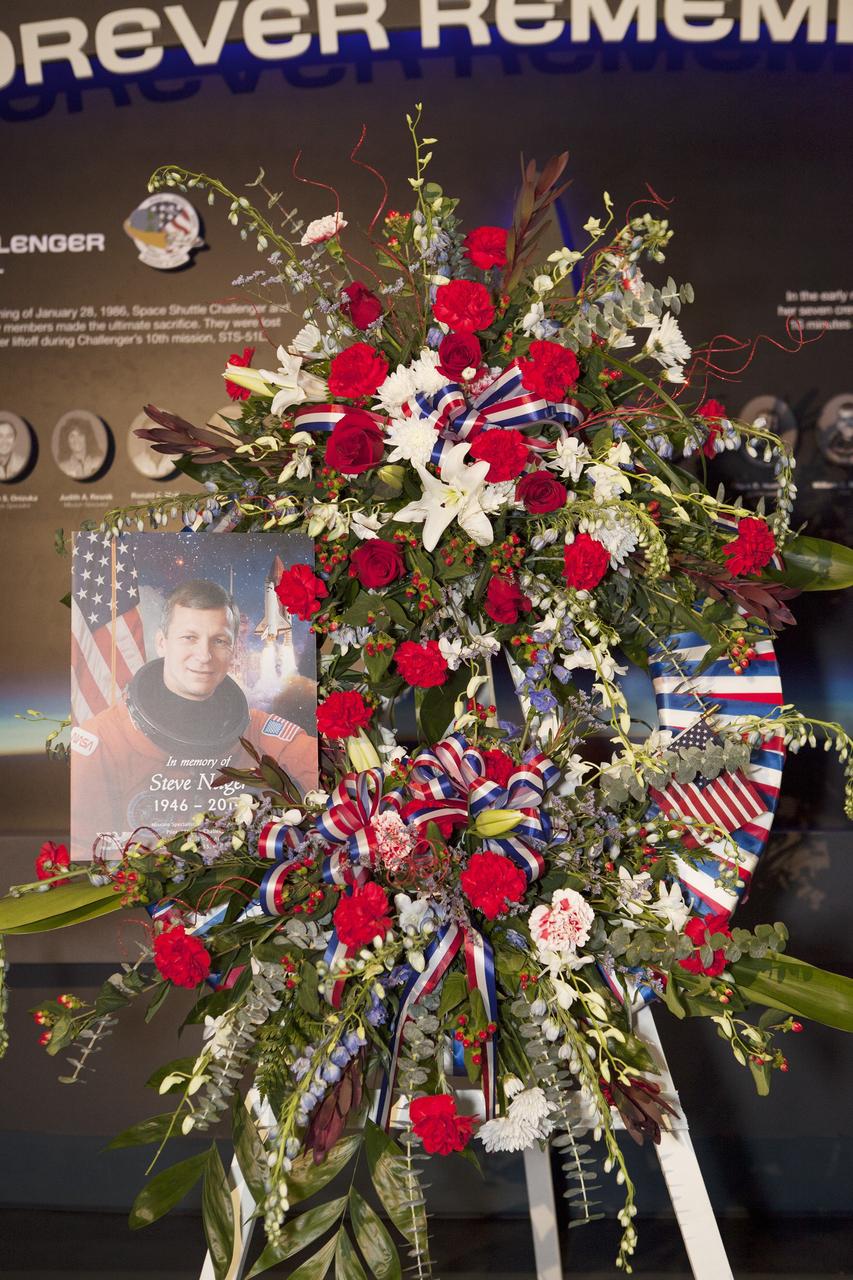 CAPE CANAVERAL, Fla. -- A wreath honoring former NASA astronaut Steven R. Nagel is displayed beside his photo at the Space Shuttle Atlantis exhibit at the Kennedy Space Center Visitor Complex in Florida. Nagel died Aug. 21 after a long illness. He was 67 years old. Nagel served as a mission specialist on his first space shuttle flight, STS-51G, in 1985. He was pilot on his second shuttle flight, STS-61A, also in 1985. He commanded his final two flights, STS-37 and STS-55, in 1991 and 1993, respectively. He logged a total of 723 hours in space. To learn more about Nagel's career, visit http://www.nasa.gov/press/2014/august/former-nasa-astronaut-steven-nagel-veteran-of-four-shuttle-flights-dies-at-67/. Photo credit: NASA/Dimitri Gerondidakis