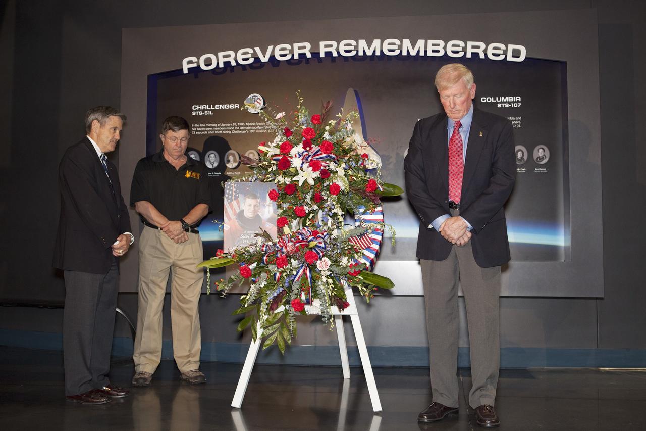 CAPE CANAVERAL, Fla. -- From left, Kennedy Space Center Director Bob Cabana, Kenneth Cameron, and Jon McBride, all former NASA astronauts, pause for reflection after placing a wreath honoring former NASA astronaut Steven R. Nagel at the Space Shuttle Atlantis exhibit at the Kennedy Space Center Visitor Complex in Florida. Nagel died Aug. 21 after a long illness. He was 67 years old. Nagel served as a mission specialist on his first space shuttle flight, STS-51G, in 1985. He was pilot on his second shuttle flight, STS-61A, also in 1985. He commanded his final two flights, STS-37 and STS-55, in 1991 and 1993, respectively. He logged a total of 723 hours in space. To learn more about Nagel's career, visit http://www.nasa.gov/press/2014/august/former-nasa-astronaut-steven-nagel-veteran-of-four-shuttle-flights-dies-at-67/. Photo credit: NASA/Dimitri Gerondidakis