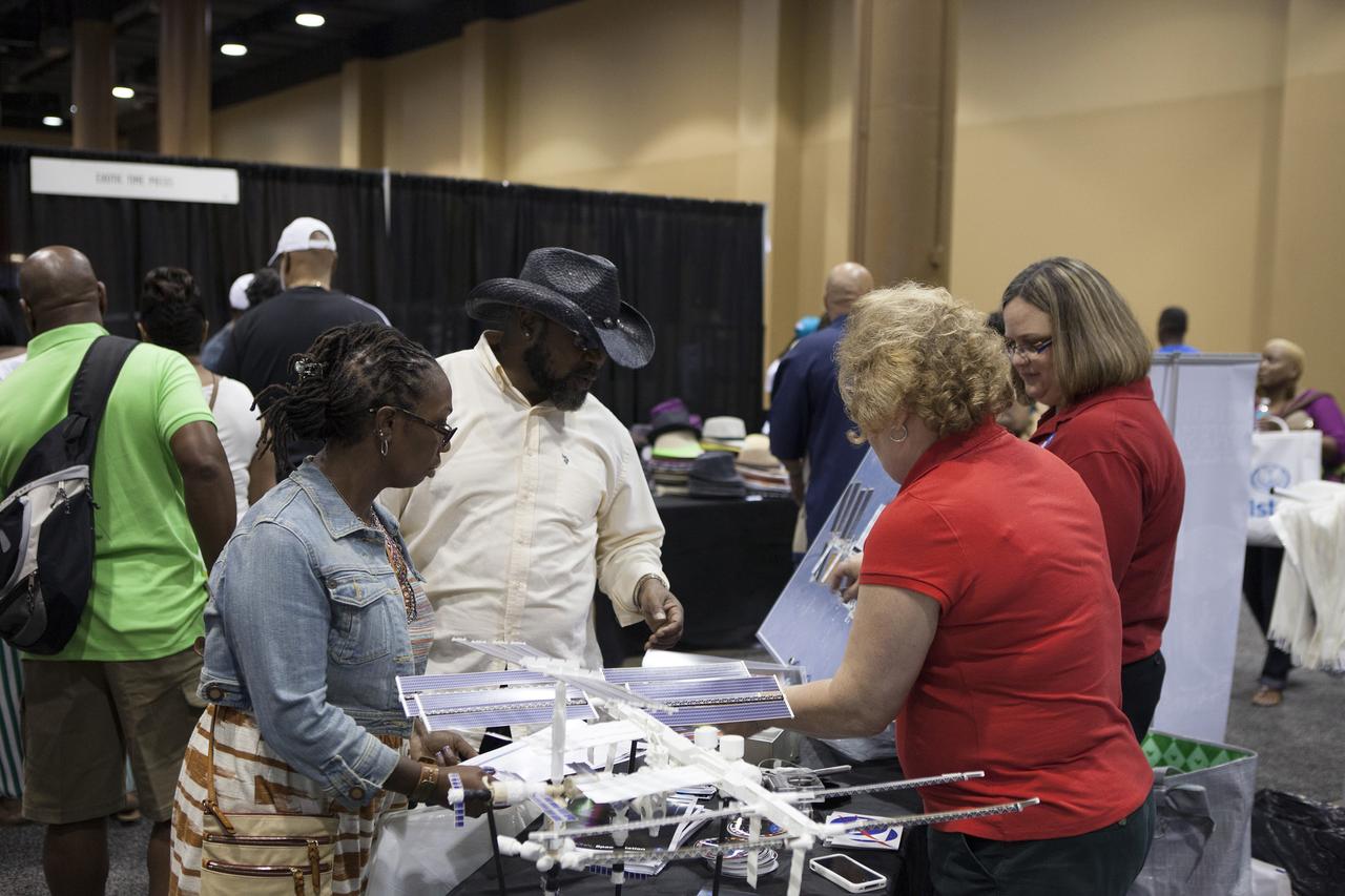 KISSIMMEE, Fla. – Guests at the Tom Joyner Family Reunion learn about NASA activities during the five-day event. Thousands of visitors spoke with agency representatives who explained the NASA’s efforts with the International Space Station, Commercial Crew Program, Ground Systems Development and Operations Program, as well as the Launch Services Program.    The Tom Joyner Family Reunion is designed to present uplifting programs, entertainment and information about growing, diverse communities. An annual event of the nationally-syndicated Tom Joyner Morning Show, the many exhibits included NASA's participation focusing on encouraging young people to consider studies and careers in STEM -- science, technology, engineering and math. NASA's Education Division promoted the benefits of math and scientific learning along with career opportunities offered by the space agency. The activities took place at the Gaylord Palms Resort in Kissimmee, Florida, during the Labor Day weekend. Photo credit: NASA/Daniel Casper