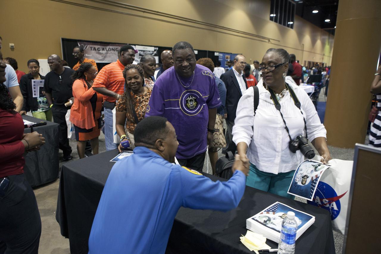 KISSIMMEE, Fla. – Former NASA astronaut Winston Scott signed autographs and posed for pictures with guests at the agency exhibit during the Tom Joyner Family Reunion. Now a senior vice president at the Florida Institute of Technology, he said that he likes to emphasize to young people how important a good education is in preparation for the future. The Tom Joyner Family Reunion is designed to present uplifting programs, entertainment and information about growing, diverse communities. An annual event of the nationally-syndicated Tom Joyner Morning Show, the many exhibits included NASA's participation focusing on encouraging young people to consider studies and careers in STEM -- science, technology, engineering and math. NASA's Education Division promoted the benefits of math and scientific learning along with career opportunities offered by the space agency. The activities took place at the Gaylord Palms Resort in Kissimmee, Florida, during the Labor Day weekend. Photo credit: NASA/Daniel Casper