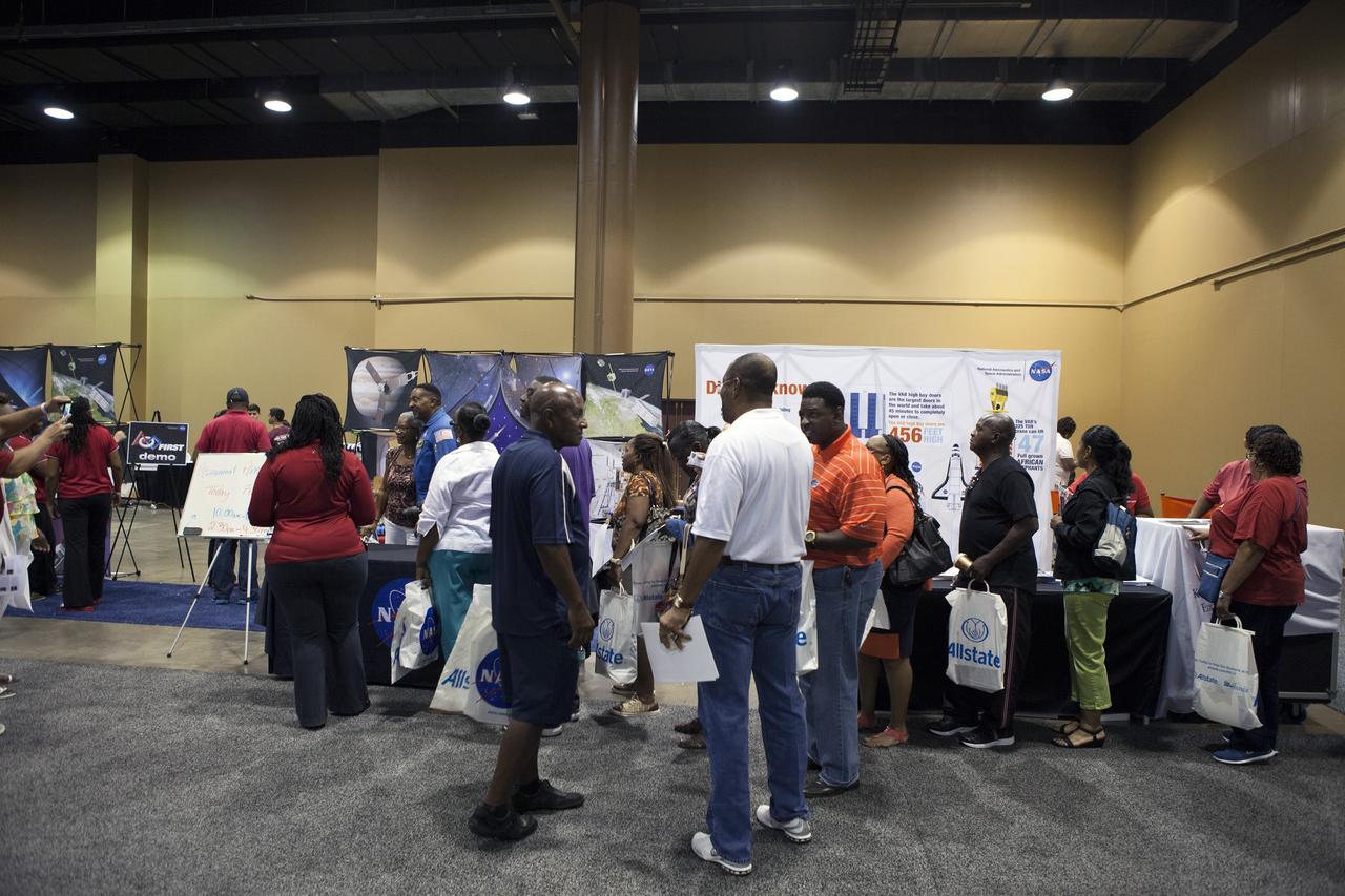 KISSIMMEE, Fla. – Guests at the Tom Joyner Family Reunion learn about NASA activities during the five-day event. Thousands of visitors spoke with agency representatives who explained the agency’s efforts with the International Space Station, Commercial Crew Program, Ground Systems Development and Operations Program, as well as the Launch Services Program.      The Tom Joyner Family Reunion is designed to present uplifting programs, entertainment and information about growing, diverse communities. An annual event of the nationally-syndicated Tom Joyner Morning Show, the many exhibits included NASA's participation focusing on encouraging young people to consider studies and careers in STEM -- science, technology, engineering and math. NASA's Education Division promoted the benefits of math and scientific learning along with career opportunities offered by the space agency. The activities took place at the Gaylord Palms Resort in Kissimmee, Florida, during the Labor Day weekend. Photo credit: NASA/Daniel Casper