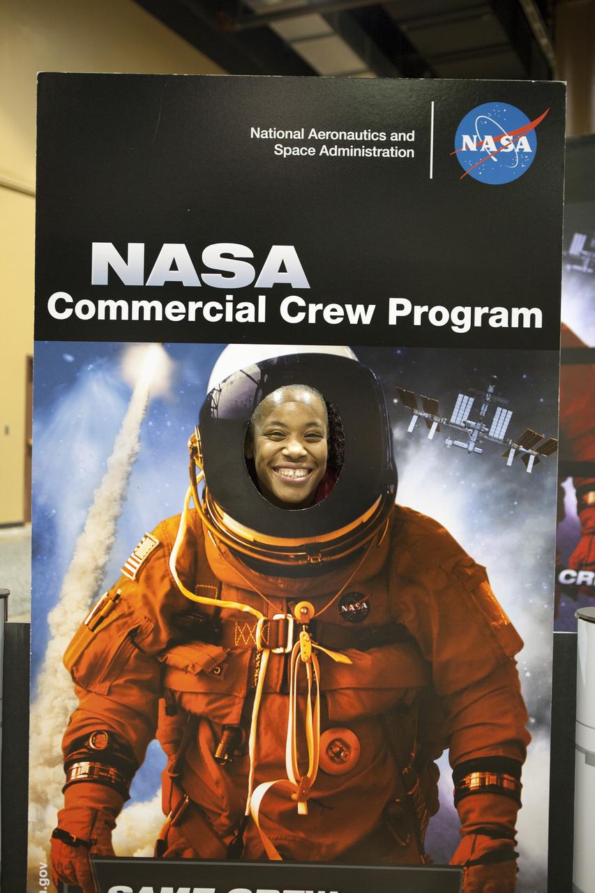 KISSIMMEE, Fla. – A guest at the Tom Joyner Family Reunion is photographed with a Commercial Crew Program exhibit during the five-day event. Thousands of visitors spoke with agency representatives who explained the agency’s efforts with CCP, the International Space Station, Ground Systems Development and Operations Program, as well as the Launch Services Program.      The Tom Joyner Family Reunion is designed to present uplifting programs, entertainment and information about growing, diverse communities. An annual event of the nationally-syndicated Tom Joyner Morning Show, the many exhibits included NASA's participation focusing on encouraging young people to consider studies and careers in STEM -- science, technology, engineering and math. NASA's Education Division promoted the benefits of math and scientific learning along with career opportunities offered by the space agency. The activities took place at the Gaylord Palms Resort in Kissimmee, Florida, during the Labor Day weekend. Photo credit: NASA/Daniel Casper