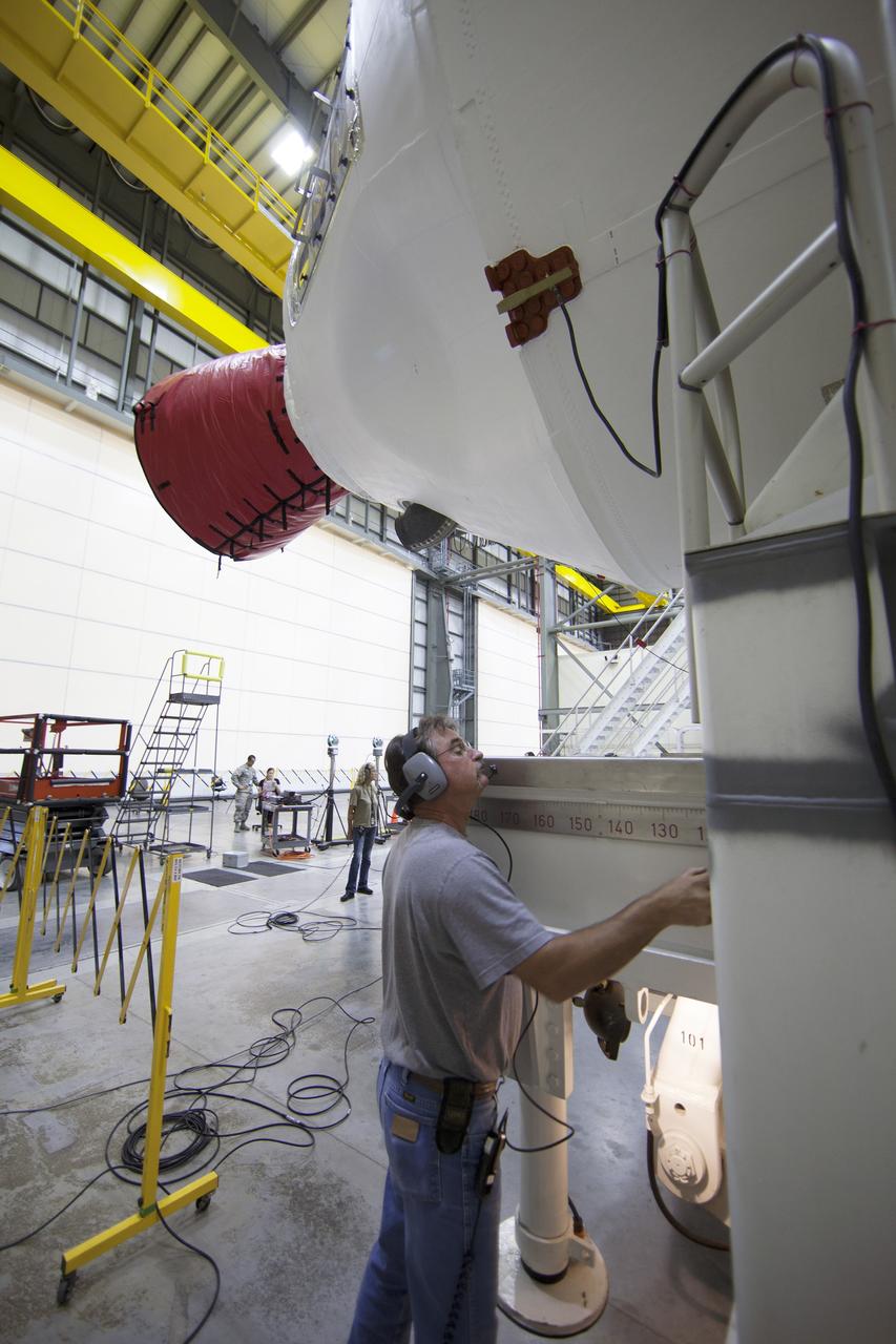 CAPE CANAVERAL, Fla. – United Launch Alliance, or ULA, technicians monitor the progress as the Delta IV port booster is mated to the core booster inside the Horizontal Integration Facility at Space Launch Complex 37 on Cape Canaveral Air Force Station in Florida. The ULA Delta IV Heavy rocket will launch an uncrewed Orion spacecraft on Exploration Flight Test-1. During the mission, Orion will travel farther into space than any human spacecraft has gone in more than 40 years. The data gathered during the flight will influence design decisions, validate existing computer models and innovative new approaches to space systems development, as well as reduce overall mission risks and costs for later Orion flights. Liftoff of Orion on the first flight test is planned for December 2014. Photo credit: NASA/Ben Smegelsky
