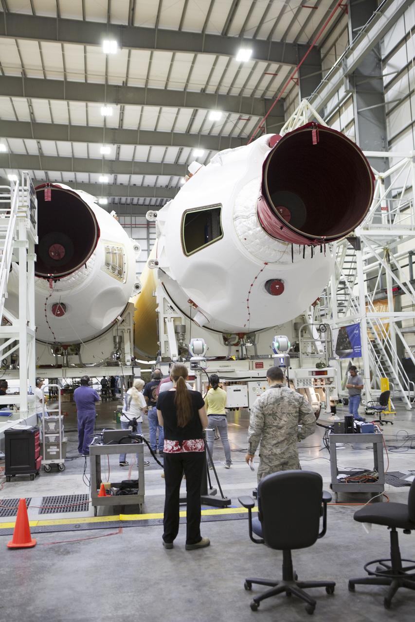 CAPE CANAVERAL, Fla. – United Launch Alliance, or ULA, technicians monitor the progress as the Delta IV port booster is mated to the core booster inside the Horizontal Integration Facility at Space Launch Complex 37 on Cape Canaveral Air Force Station in Florida. The ULA Delta IV Heavy rocket will launch an uncrewed Orion spacecraft on Exploration Flight Test-1. During the mission, Orion will travel farther into space than any human spacecraft has gone in more than 40 years. The data gathered during the flight will influence design decisions, validate existing computer models and innovative new approaches to space systems development, as well as reduce overall mission risks and costs for later Orion flights. Liftoff of Orion on the first flight test is planned for December 2014. Photo credit: NASA/Ben Smegelsky