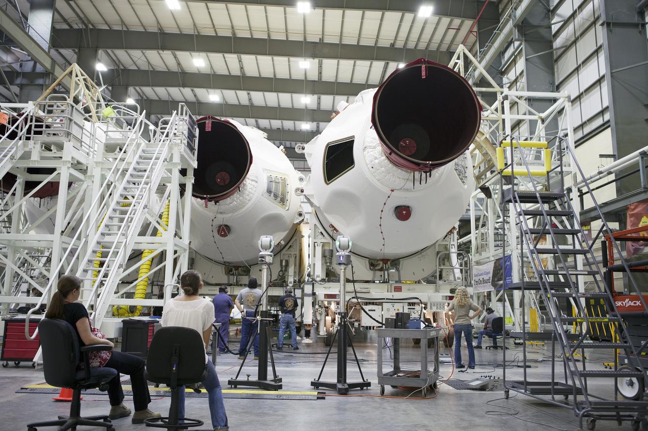 CAPE CANAVERAL, Fla. – United Launch Alliance, or ULA, technicians monitor the progress as the Delta IV port booster is mated to the core booster inside the Horizontal Integration Facility at Space Launch Complex 37 on Cape Canaveral Air Force Station in Florida. The ULA Delta IV Heavy rocket will launch an uncrewed Orion spacecraft on Exploration Flight Test-1. During the mission, Orion will travel farther into space than any human spacecraft has gone in more than 40 years. The data gathered during the flight will influence design decisions, validate existing computer models and innovative new approaches to space systems development, as well as reduce overall mission risks and costs for later Orion flights. Liftoff of Orion on the first flight test is planned for December 2014. Photo credit: NASA/Ben Smegelsky