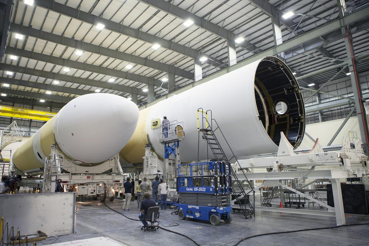 CAPE CANAVERAL, Fla. – United Launch Alliance, or ULA, technicians monitor the progress as the Delta IV port booster is mated to the core booster inside the Horizontal Integration Facility at Space Launch Complex 37 on Cape Canaveral Air Force Station in Florida. The ULA Delta IV Heavy rocket will launch an uncrewed Orion spacecraft on Exploration Flight Test-1. During the mission, Orion will travel farther into space than any human spacecraft has gone in more than 40 years. The data gathered during the flight will influence design decisions, validate existing computer models and innovative new approaches to space systems development, as well as reduce overall mission risks and costs for later Orion flights. Liftoff of Orion on the first flight test is planned for December 2014. Photo credit: NASA/Ben Smegelsky