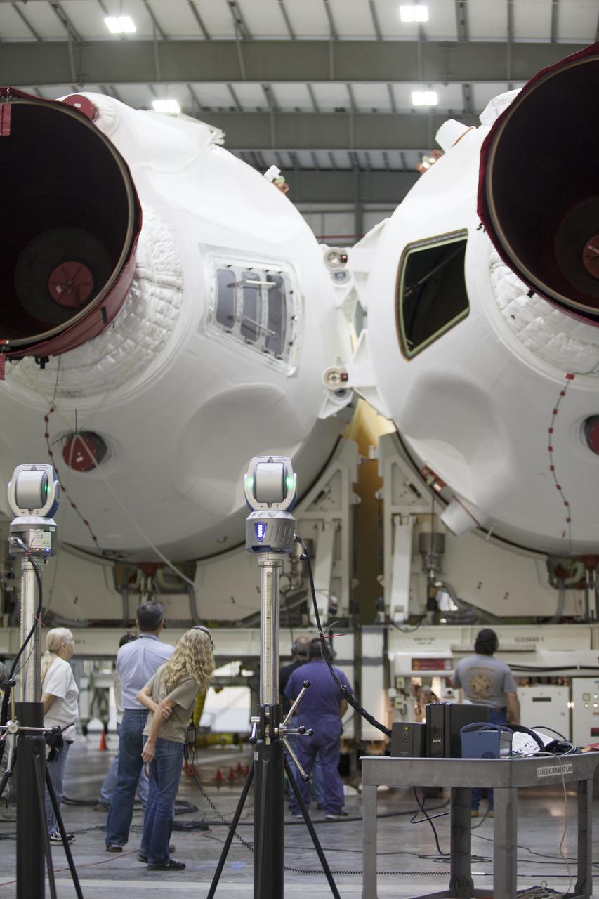 CAPE CANAVERAL, Fla. – United Launch Alliance, or ULA, technicians monitor the progress as the Delta IV port booster is mated to the core booster inside the Horizontal Integration Facility at Space Launch Complex 37 on Cape Canaveral Air Force Station in Florida. The ULA Delta IV Heavy rocket will launch an uncrewed Orion spacecraft on Exploration Flight Test-1. During the mission, Orion will travel farther into space than any human spacecraft has gone in more than 40 years. The data gathered during the flight will influence design decisions, validate existing computer models and innovative new approaches to space systems development, as well as reduce overall mission risks and costs for later Orion flights. Liftoff of Orion on the first flight test is planned for December 2014. Photo credit: NASA/Ben Smegelsky