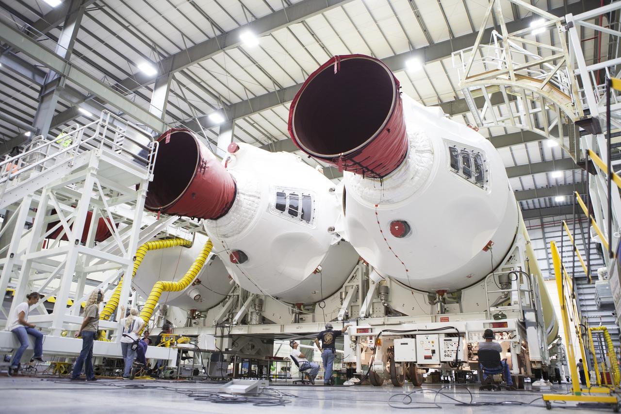 CAPE CANAVERAL, Fla. – All three of the United Launch Alliance, or ULA, Delta IV boosters for Exploration Flight Test-1 are in view inside the Horizontal Integration Facility at Space Launch Complex 37 on Cape Canaveral Air Force Station in Florida. The port booster is being mated to the core booster. The ULA Delta IV Heavy rocket will launch an uncrewed Orion spacecraft on Exploration Flight Test-1. During the mission, Orion will travel farther into space than any human spacecraft has gone in more than 40 years. The data gathered during the flight will influence design decisions, validate existing computer models and innovative new approaches to space systems development, as well as reduce overall mission risks and costs for later Orion flights. Liftoff of Orion on the first flight test is planned for December 2014. Photo credit: NASA/Ben Smegelsky