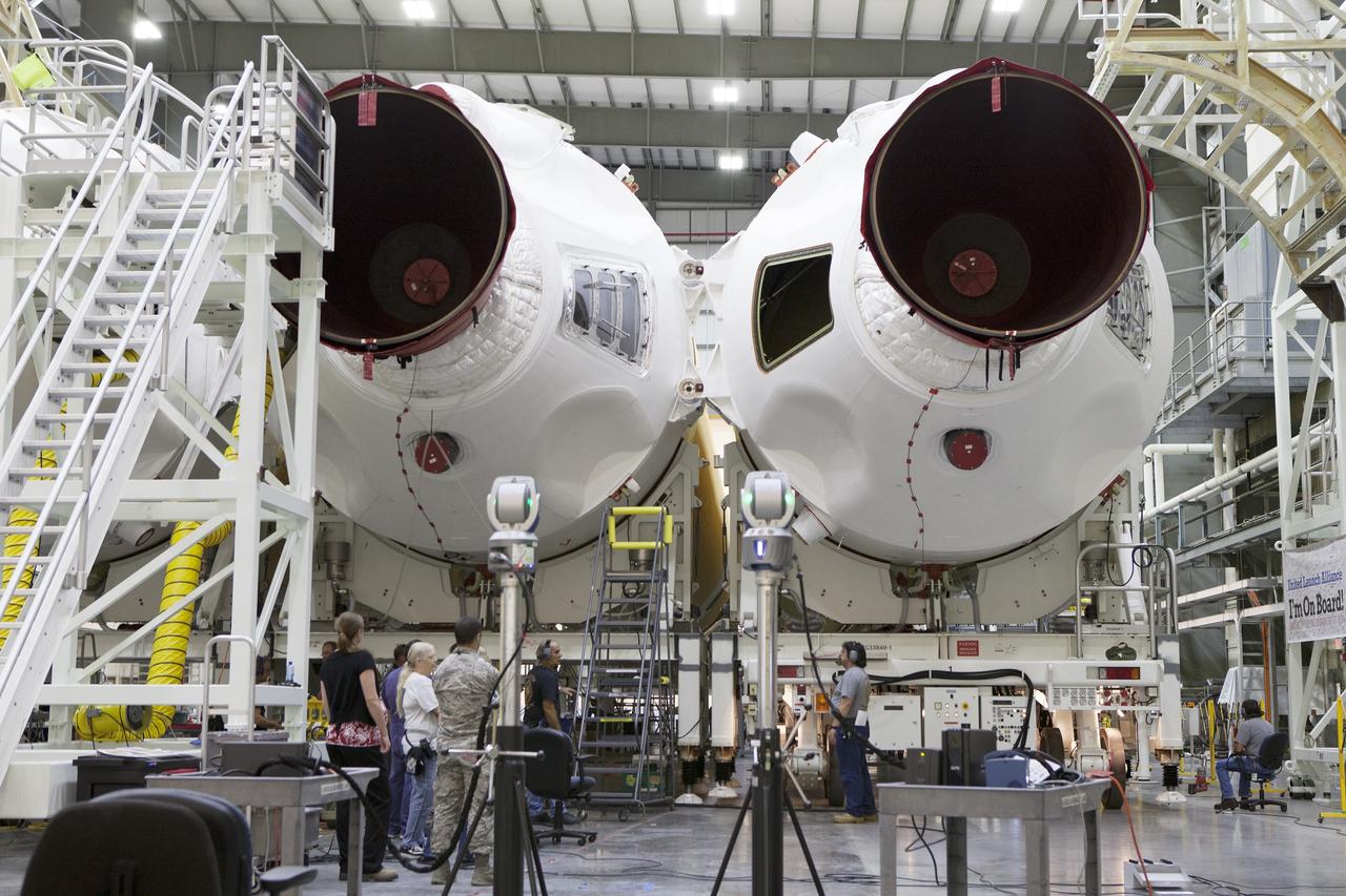 CAPE CANAVERAL, Fla. – United Launch Alliance, or ULA, technicians monitor the progress as the Delta IV port booster is mated to the core booster inside the Horizontal Integration Facility at Space Launch Complex 37 on Cape Canaveral Air Force Station in Florida. The ULA Delta IV Heavy rocket will launch an uncrewed Orion spacecraft on Exploration Flight Test-1. During the mission, Orion will travel farther into space than any human spacecraft has gone in more than 40 years. The data gathered during the flight will influence design decisions, validate existing computer models and innovative new approaches to space systems development, as well as reduce overall mission risks and costs for later Orion flights. Liftoff of Orion on the first flight test is planned for December 2014. Photo credit: NASA/Ben Smegelsky