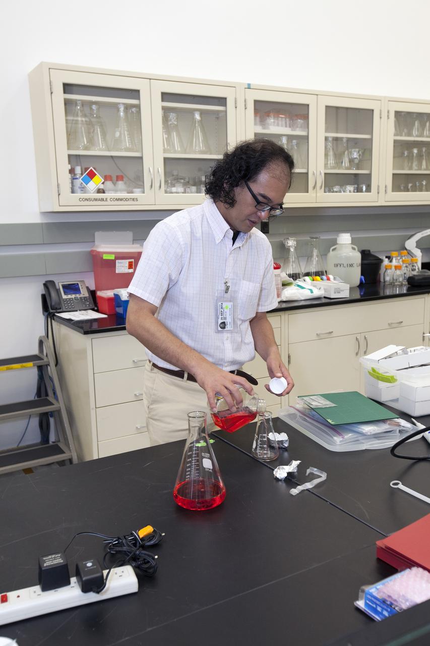 CAPE CANAVERAL, Fla. – Inside a laboratory in the Space Station Processing Facility at NASA's Kennedy Space Center in Florida, Akira Higashibata, a scientist with the Japan Aerospace Exploration Agency, or JAXA, prepares fluid to hold samples for the Cell-Mechanosensing 2 experiment for JAXA. The experiment is one of many that will be delivered to the International Space Station on the SpaceX-4 commercial cargo resupply mission. Kennedy's ISS Ground Processing and Research Project Office is providing the necessary laboratories, equipment, supplies and consumables for 61 principal investigators, including 17 from other countries, as they prepare their science experiments for flight. The SpaceX-4 flight is targeted to launch in September 2014. Photo credit: NASA/Dimitri Gerondidakis
