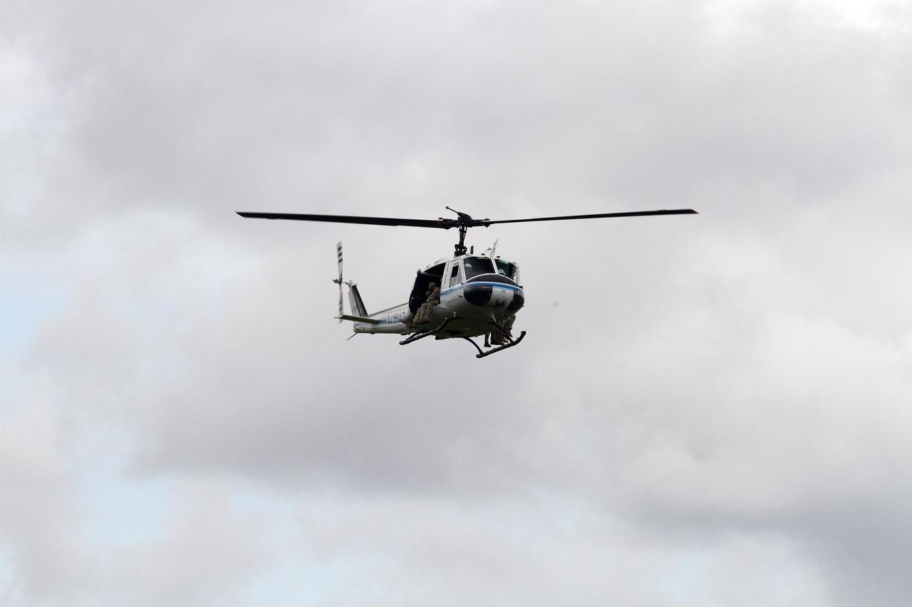 CAPE CANAVERAL, Fla. – A Huey helicopter from the Aircraft Operations branch at NASA's Kennedy Space Center in Florida slows to a hover and descends on a clearing during a training exercise with a group of Emergency Response Team officers from the center's Protective Services branch. The flight was the beginning of a training mission to simulate a situation the team and pilots could confront at the center. Photo credit: NASA/Dan Casper