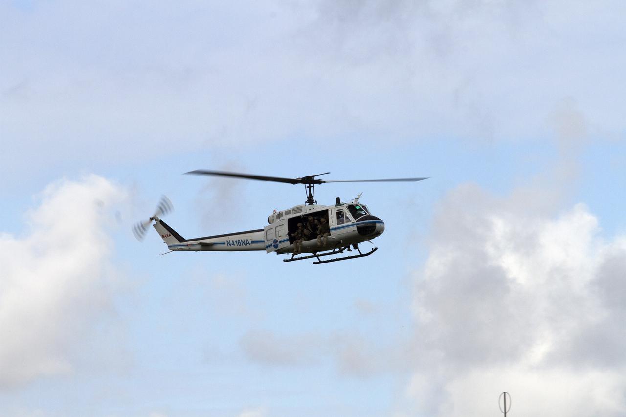 CAPE CANAVERAL, Fla. – A Huey helicopter from the Aircraft Operations branch at NASA's Kennedy Space Center in Florida slows to a hover and descends on a clearing during a training exercise with a group of Emergency Response Team officers from the center's Protective Services branch. The flight was the beginning of a training mission to simulate a situation the team and pilots could confront at the center. Photo credit: NASA/Dan Casper